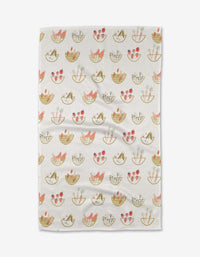 The Garden Fresh Tea Towel by Anee Shah features a charming pattern of baskets with cats and pink flowers in soft pink, tan, and green on a subtle grid. Made from Geoweave™ fabric for exceptional softness.