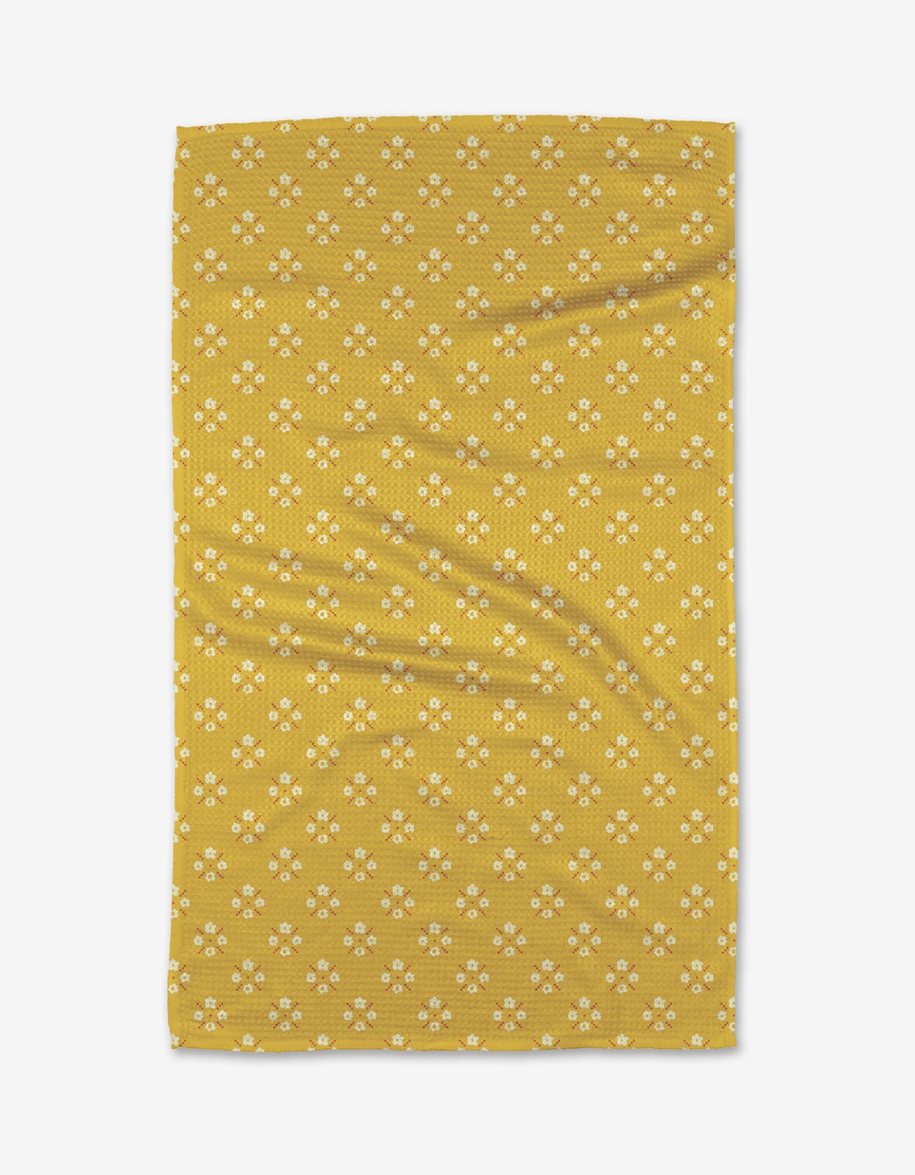 The Garden Lattice Tea Towel by Kelsey Weigl features yellow Geoweave™ fabric with a repeating pattern of small white and yellow flowers, shown flat with slight creases.