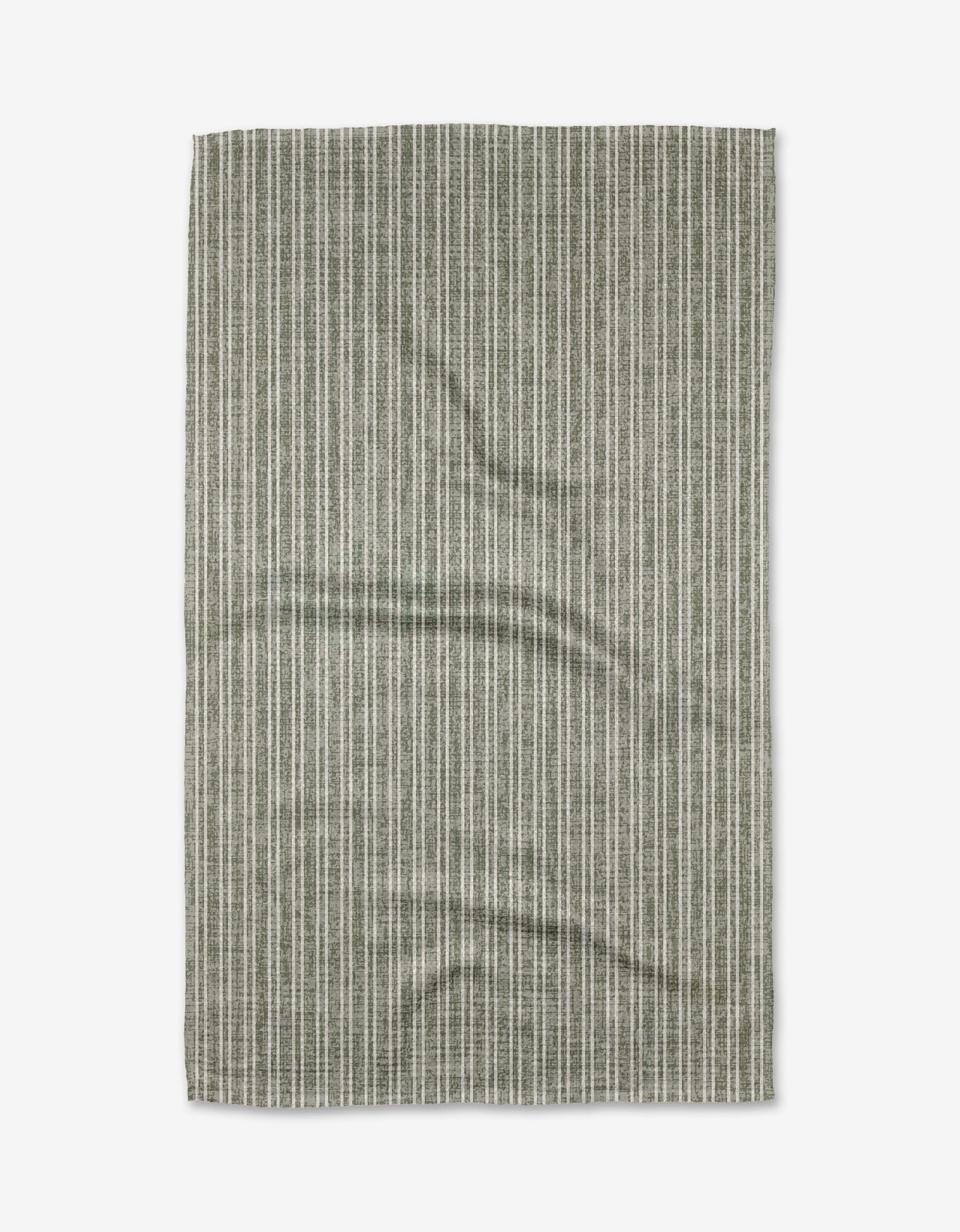 The Garff Sage tea towel by Becki Owens features a green and white vertical pinstripe pattern on soft Geoweave fabric. This rectangular towel is slightly wrinkled and shown against a white background.