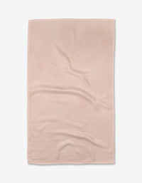 The Harper Pink tea towel by Kailee Wright features a light pink, rectangular design with a subtle textured pattern. Made from ultra-absorbent Geoweave™ fabric for efficient drying, its shown flat with slight wrinkles on a white background.