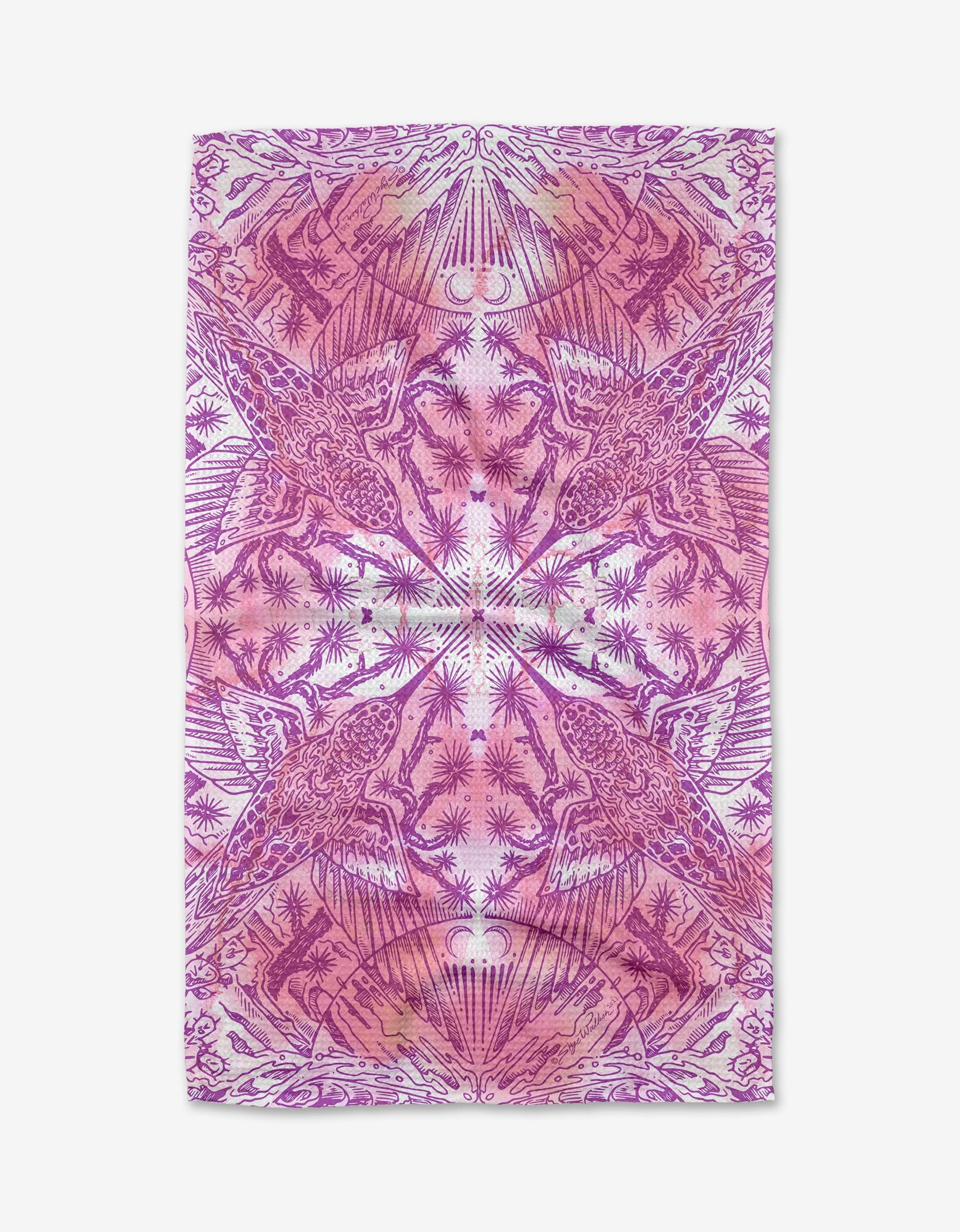The Hummingbird tea towel by Skye Walker is made from quick-drying recycled materials and showcases a magenta and pink symmetrical pattern with stylized birds, plants, and abstract shapes in a mirrored, kaleidoscopic design.