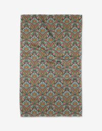 The Jungle Sunrise tea towel by Amita Nair features a repeating pattern of fan-shaped arches in muted teal, coral, and gold with stylized floral motifs inside each arch, laid flat on a white background.