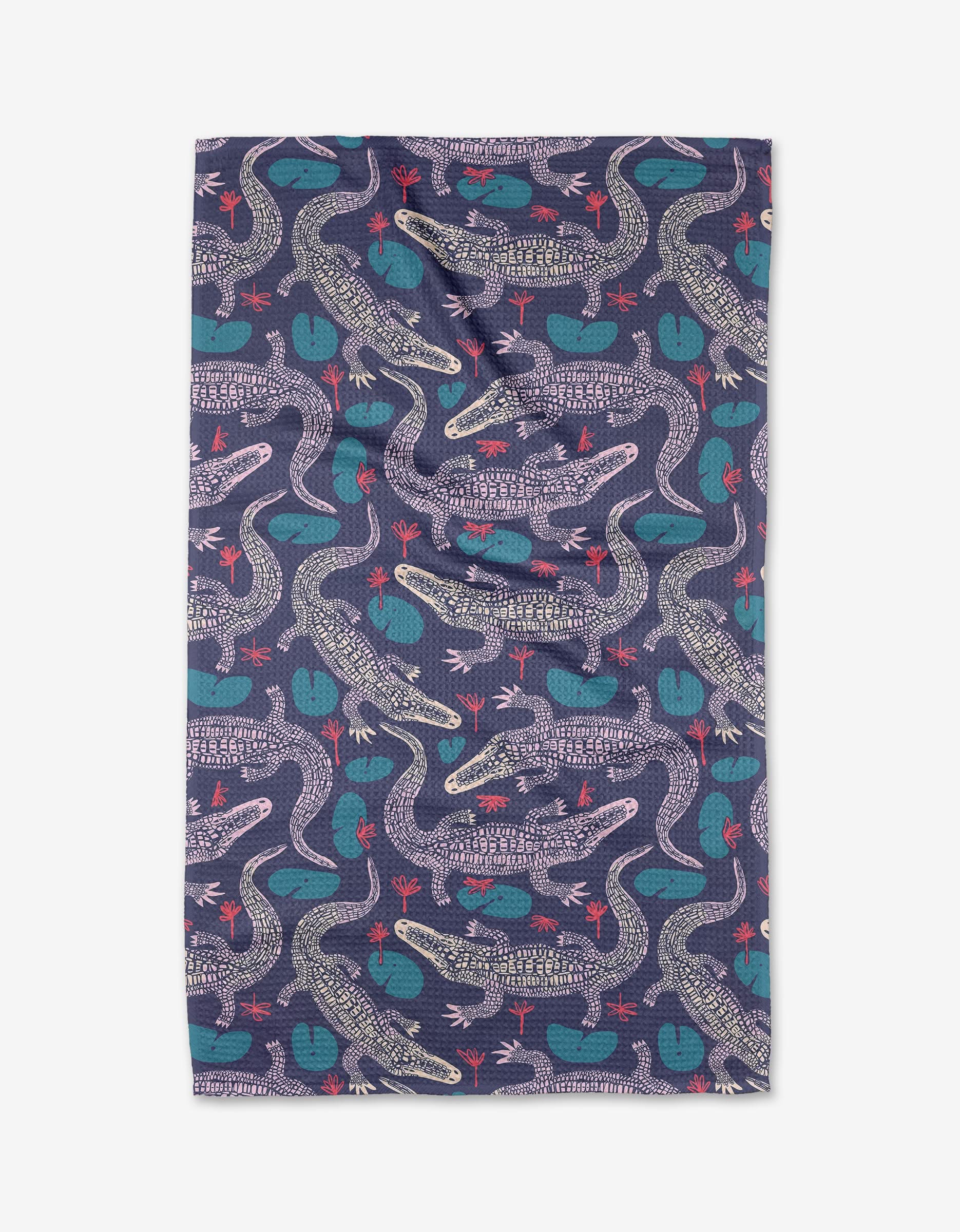 The Lillygator tea towel by Elisabeth Wing features a playful navy blue geometric pattern with crocodiles, teal lily pads, and red birds on Geoweave fabric, highlighted by detailed overlapping designs for a fun accent.