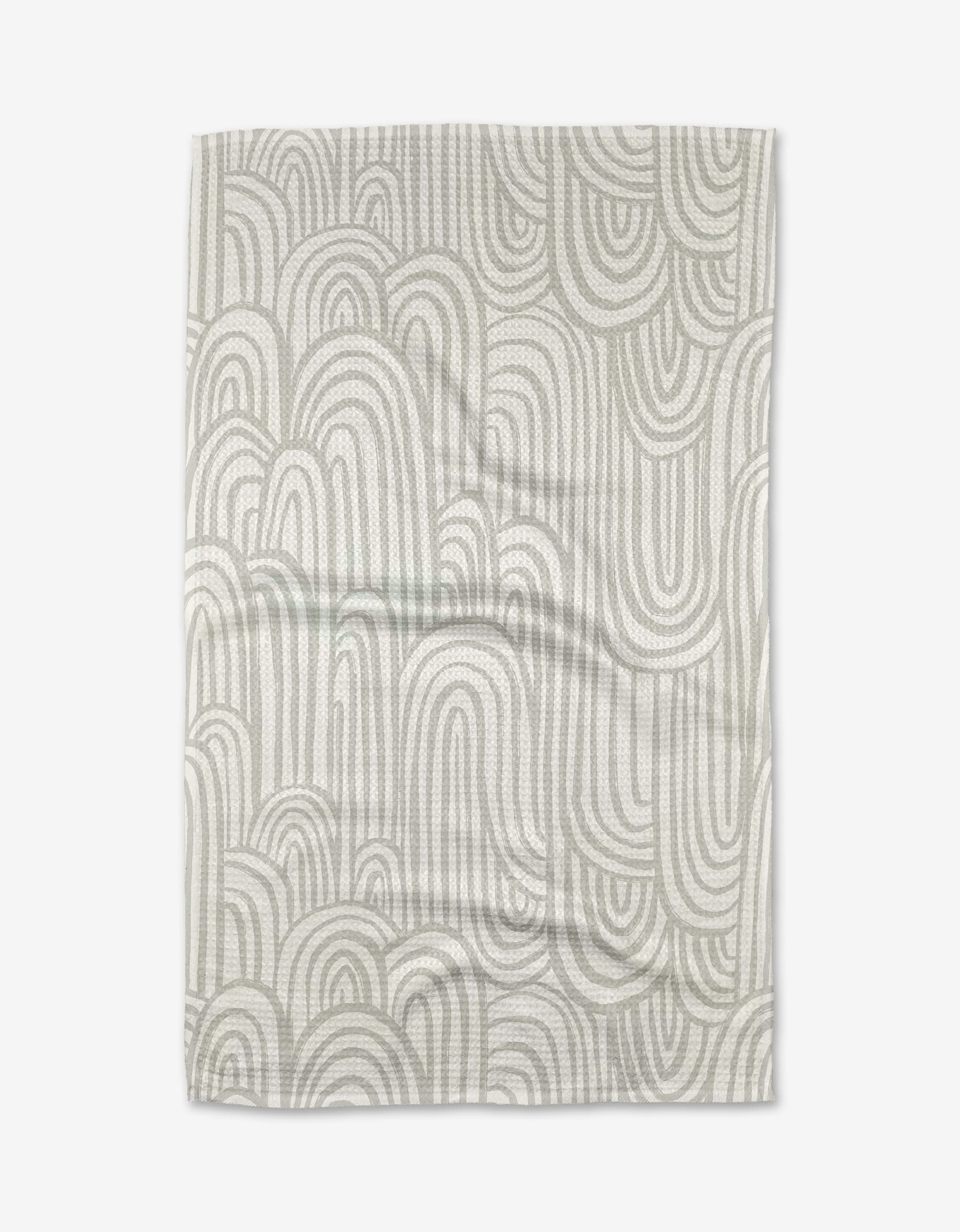 The Lovers Arc tea towel by Hufton Studio features an abstract pattern of overlapping light gray arches on a white background. Made from ultra-absorbent, slightly wrinkled fabric, it offers a casual and modern touch to your kitchen.