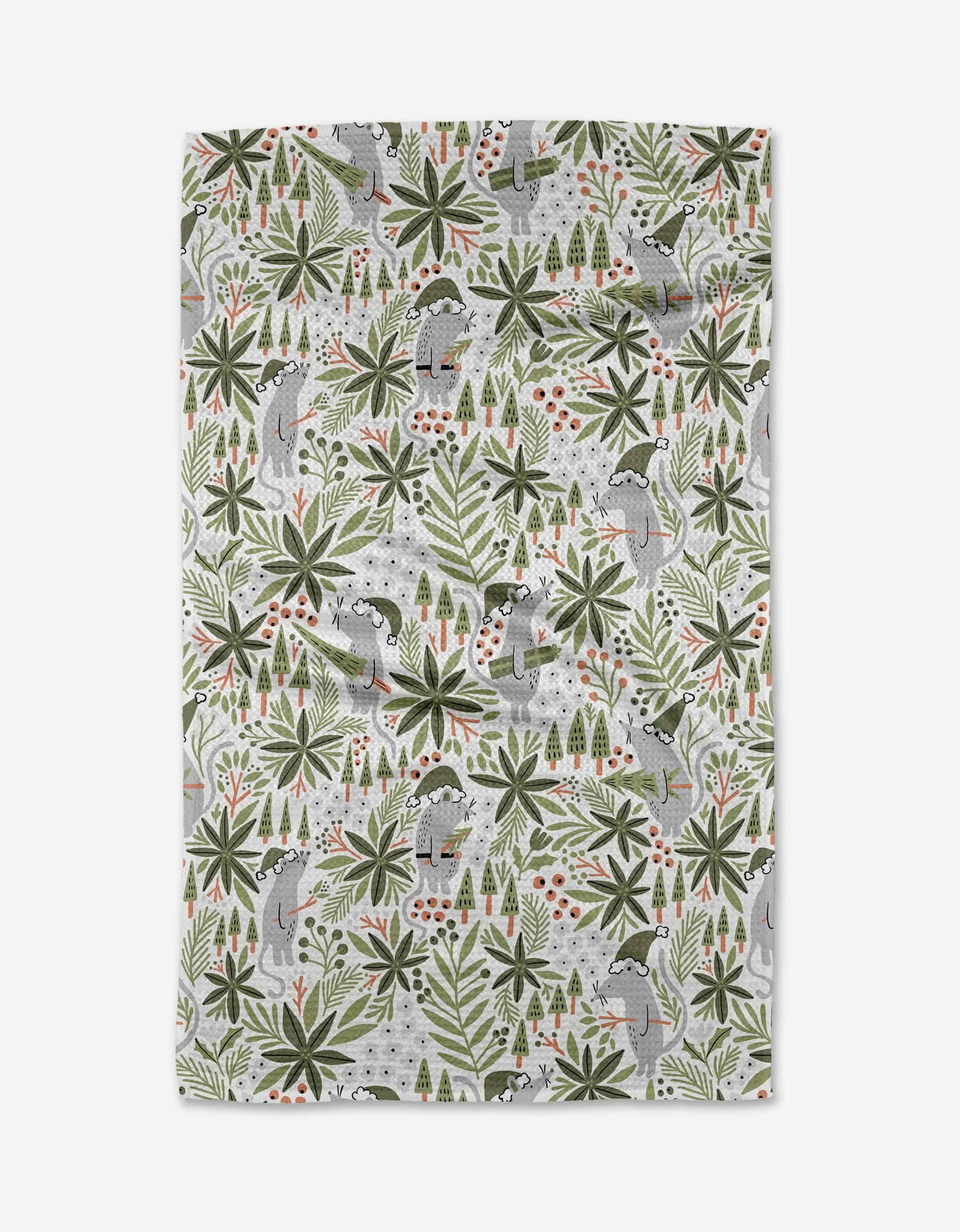 The Lucian tea towel by Amy MacCready is made from recycled materials and showcases playful lemurs, green tropical leaves, and red berries on a white background with a repeating pattern across the quick-drying fabric.