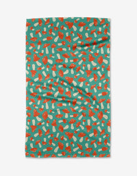 The “Mushrooms” tea towel by Megan Kampa is teal, crafted from recycled materials, and features a repeating pattern of red and white mushrooms on a lightly wrinkled surface.