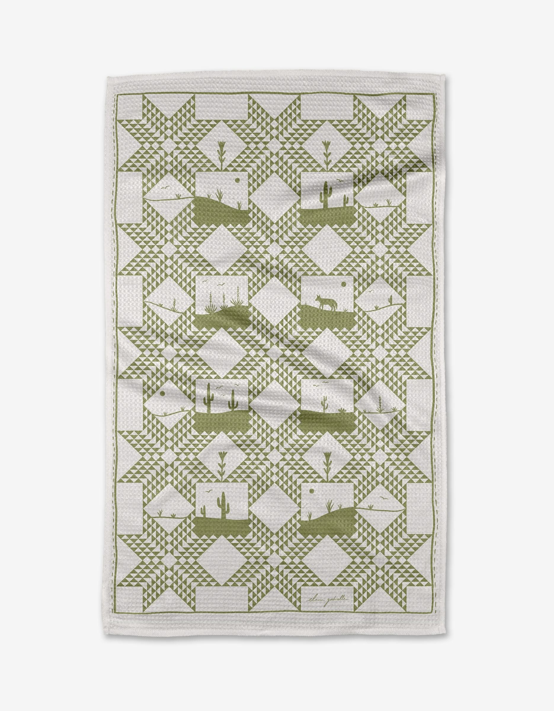 The Quilt Landscape tea towel by Elana Gabrielle features a green geometric star pattern and southwestern desert scenes on highly absorbent Geoweave fabric, blending style and function.