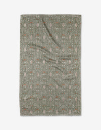 The Rulon Sage rug by Becki Owens is a rectangular green mat made from ultra-absorbent Geoweave fabric, featuring subtle cream and rust geometric and floral patterns, displayed flat on a white background.