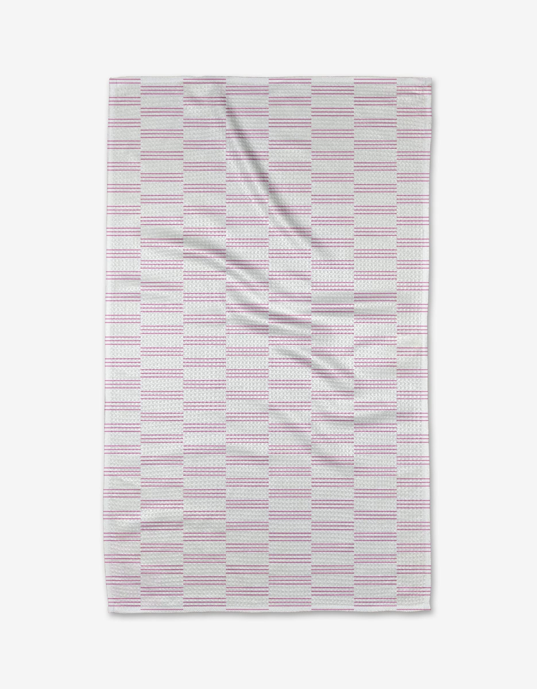 The Buy Guide’s Small Stripe - Pink Tea Towel features a rectangular design with pink and gray stripes on white. Made from soft, recycled fabric, it has gentle wrinkles for a cozy, lived-in appeal.