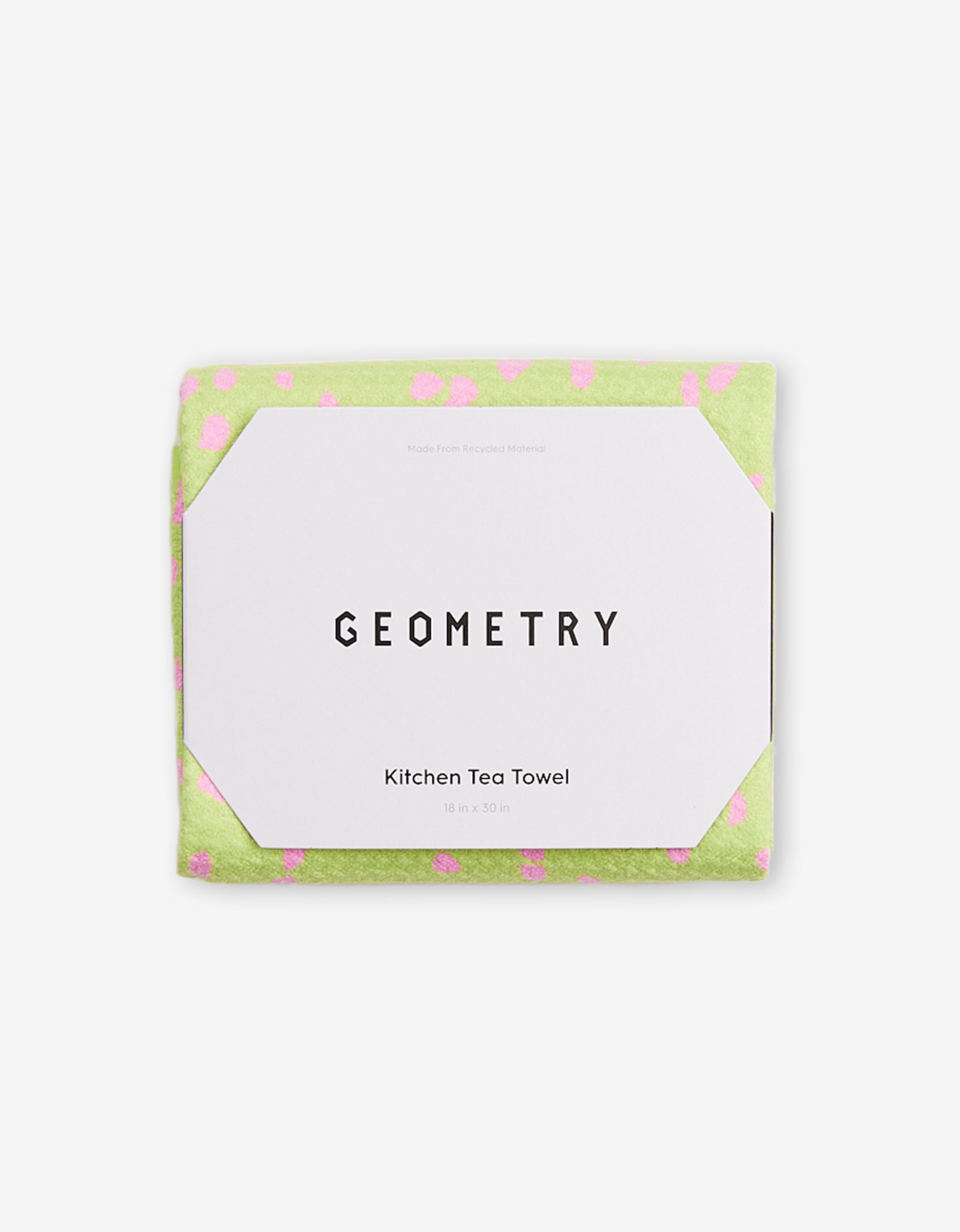 The GEOMETRY Speckle Green kitchen tea towel, made from Geoweave fabric with pink polka dots and measuring 18 x 30 inches, comes folded in white packaging labeled GEOMETRY.
