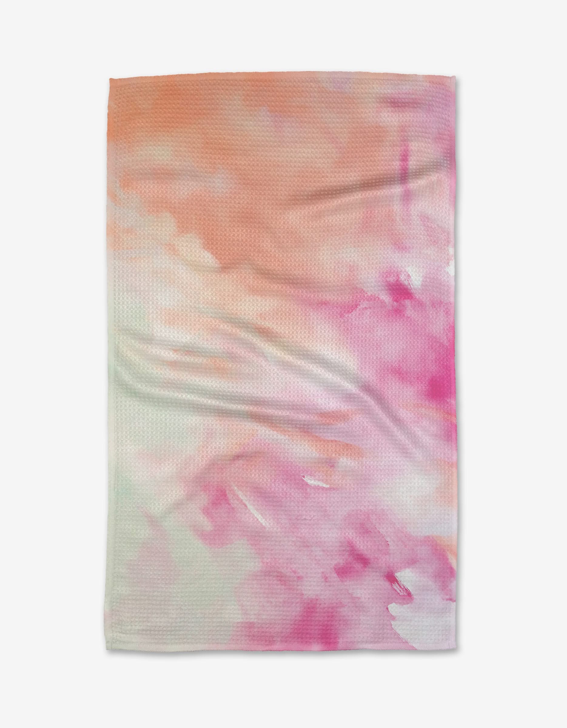 The Spring Garden tea towel by Stefanie Bales features a watercolor pattern in peach, orange, and pink with soft blended brush strokes and subtle creases on a rectangular design.