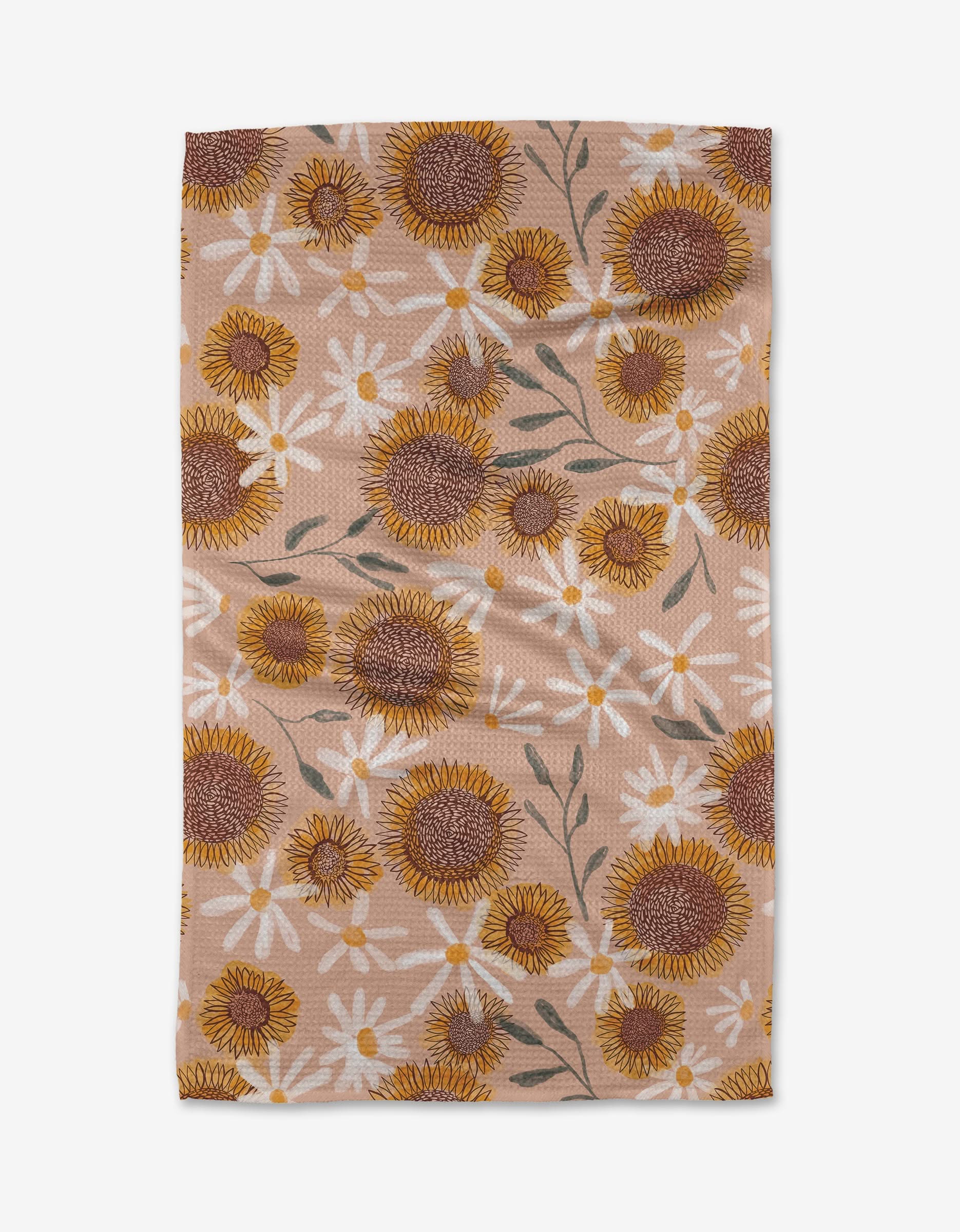 The Elisabeth Wing Sunflowers tea towel is rectangular, beige, made from Geoweave fabric, and features yellow sunflowers and white daisies with green leaves.