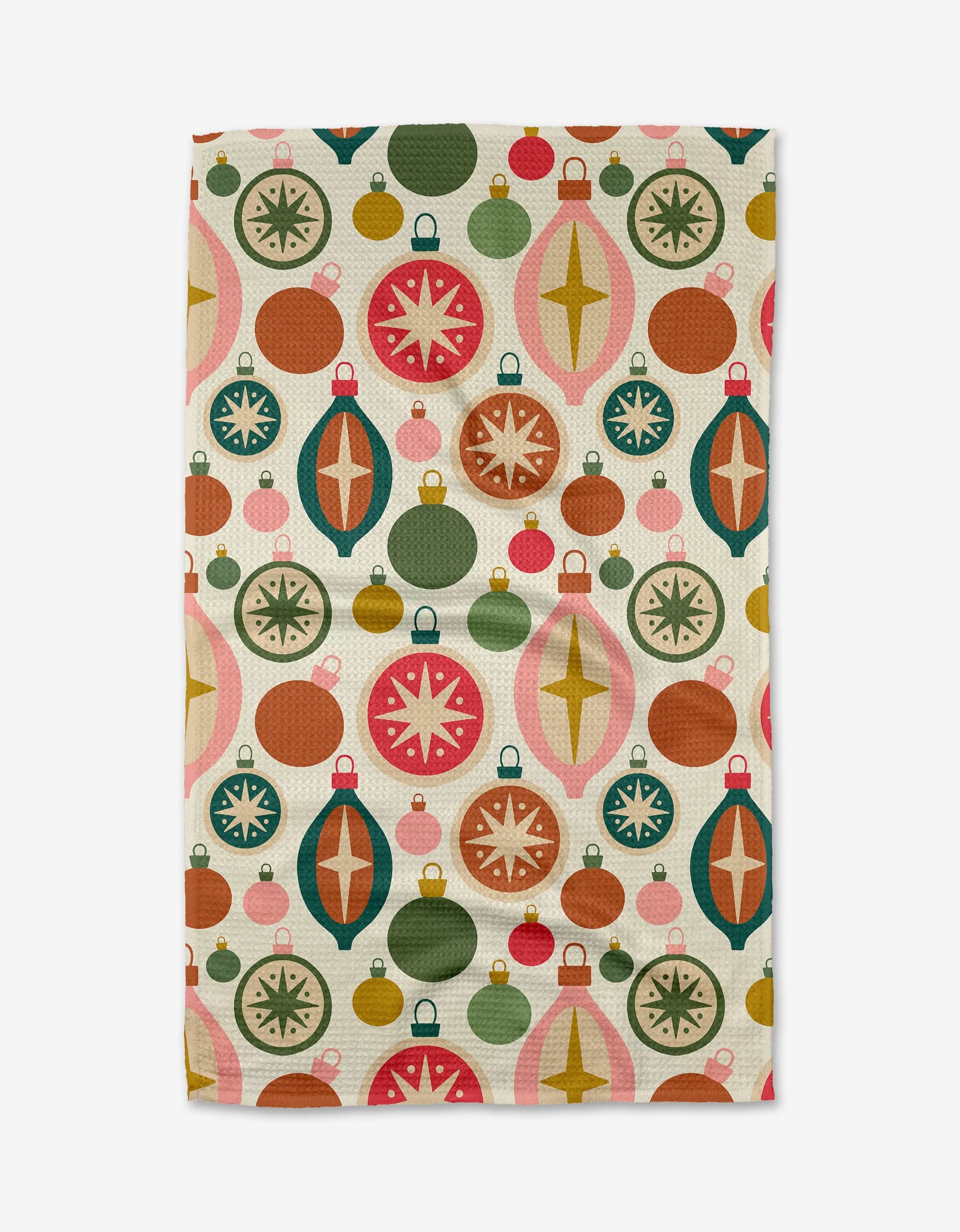 The Tinsel tea towel by Rebecca Woolbright features a vibrant pattern of vintage-style Christmas ornaments in red, green, gold, and pink on a light background—crafted from absorbent recycled materials.