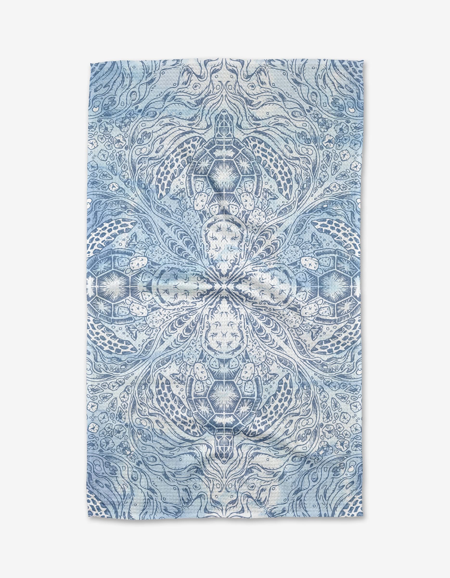A blue and white Skye Walker Turtle Tea Towel with a symmetrical, intricate pattern of swirling lines and nature-inspired designs. Crafted from soft Geoweave™ fabric for lasting quality.