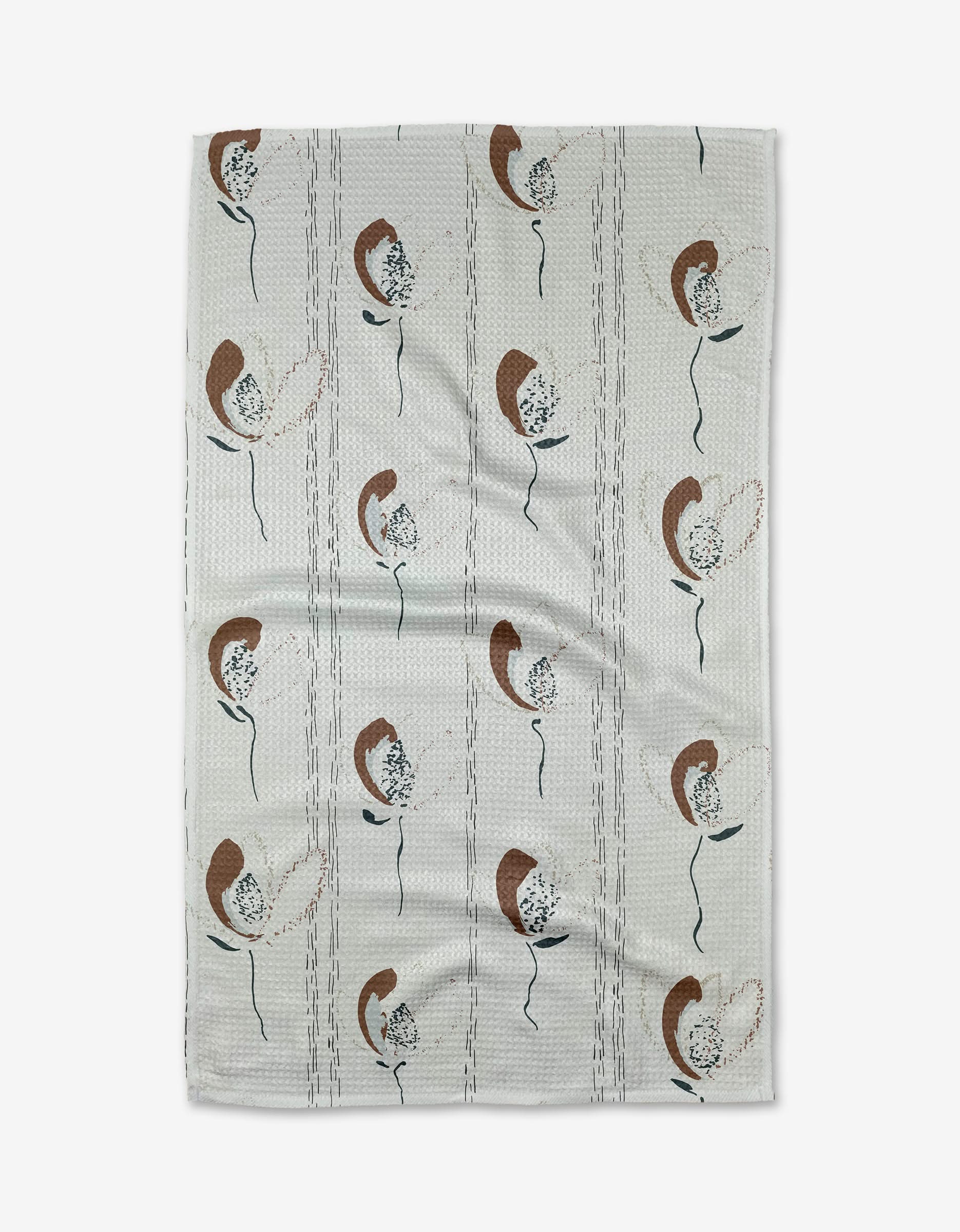 The Toboggan Avenue Vintage towel is ultra-absorbent and white, featuring abstract brown, beige, and dark green floral patterns in vertical rows with subtle textured lines for added style.