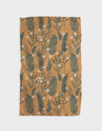The GEOMETRY Western Pines Tea Towel features a mustard yellow Geoweave fabric with a botanical pattern of green leaves and small white flowers in vertical rows.