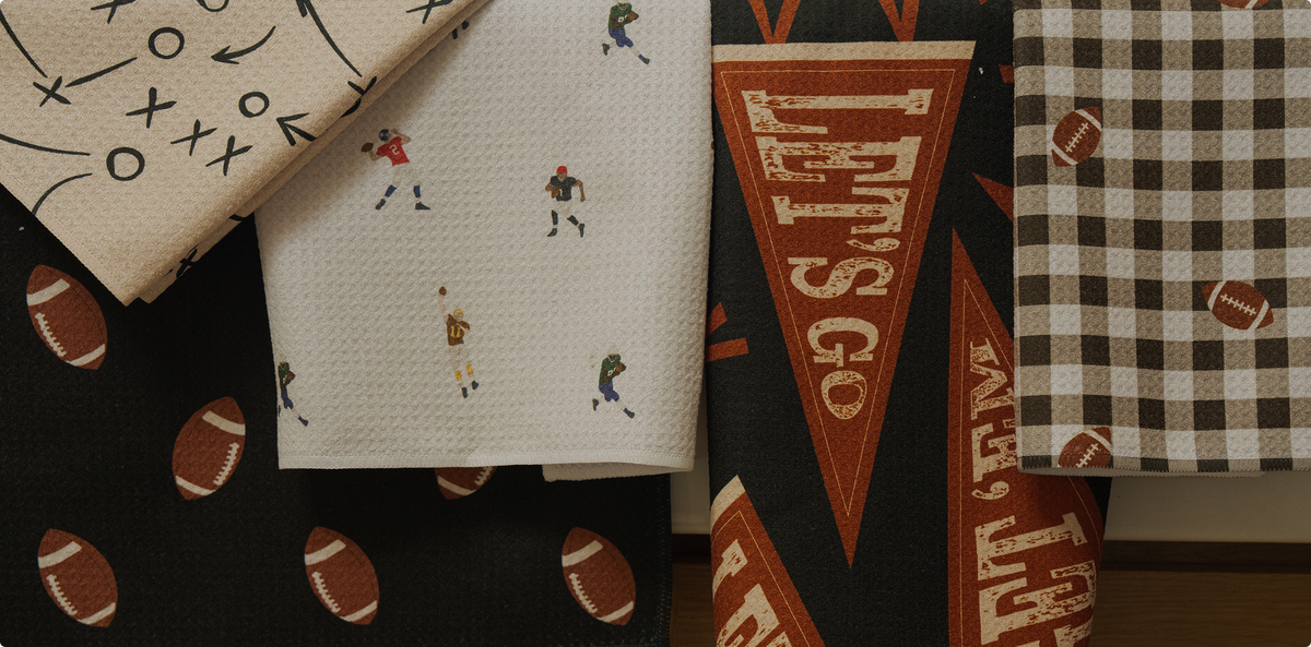 Four folded fabric patterns featuring football themes: a play diagram, players, Lets Go pennants, and a brown checkered print with footballs.