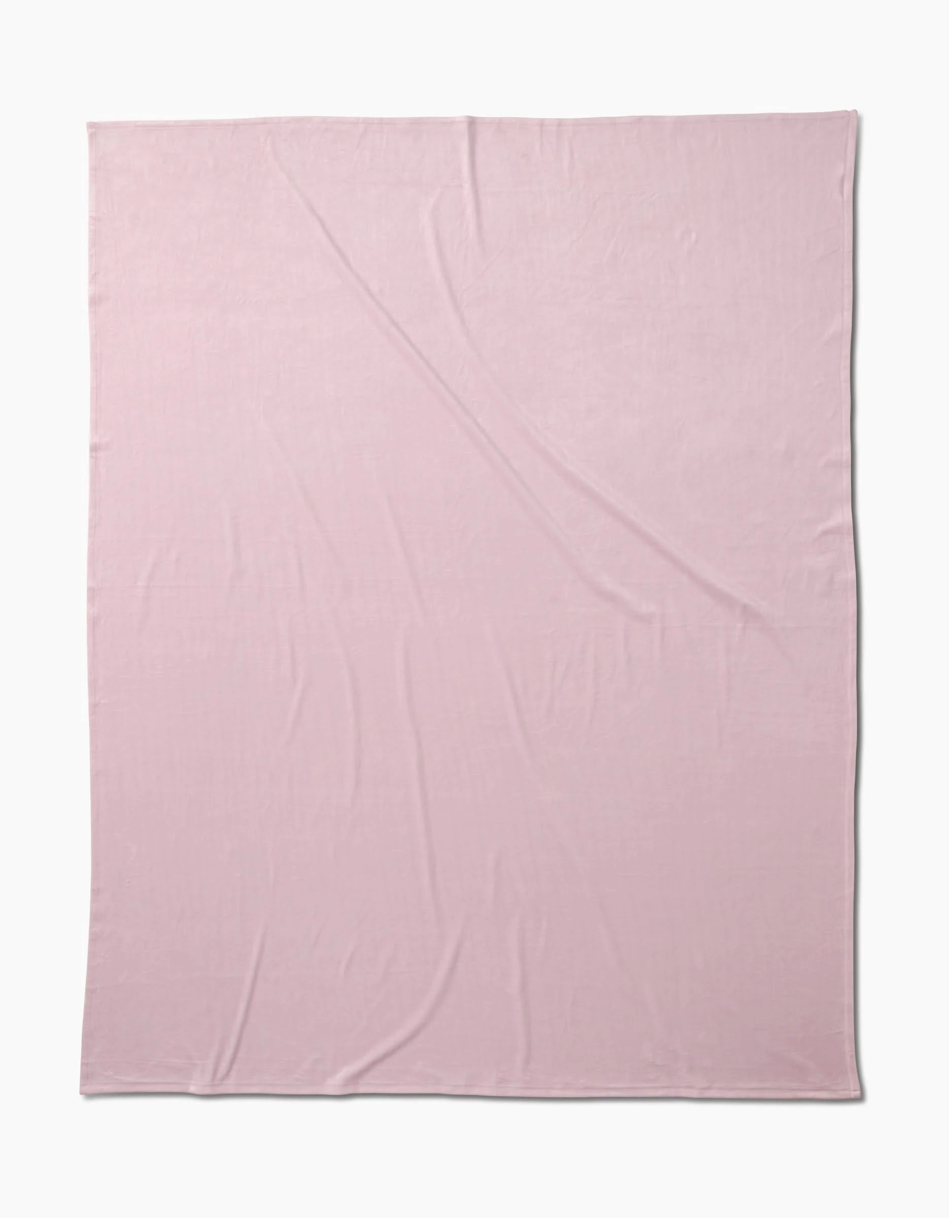 The GEOMETRY Berry Shortcake Butter Blanket, in light pink with subtle creases, is displayed on a plain white background, showcasing its silky softness for ultimate comfort.