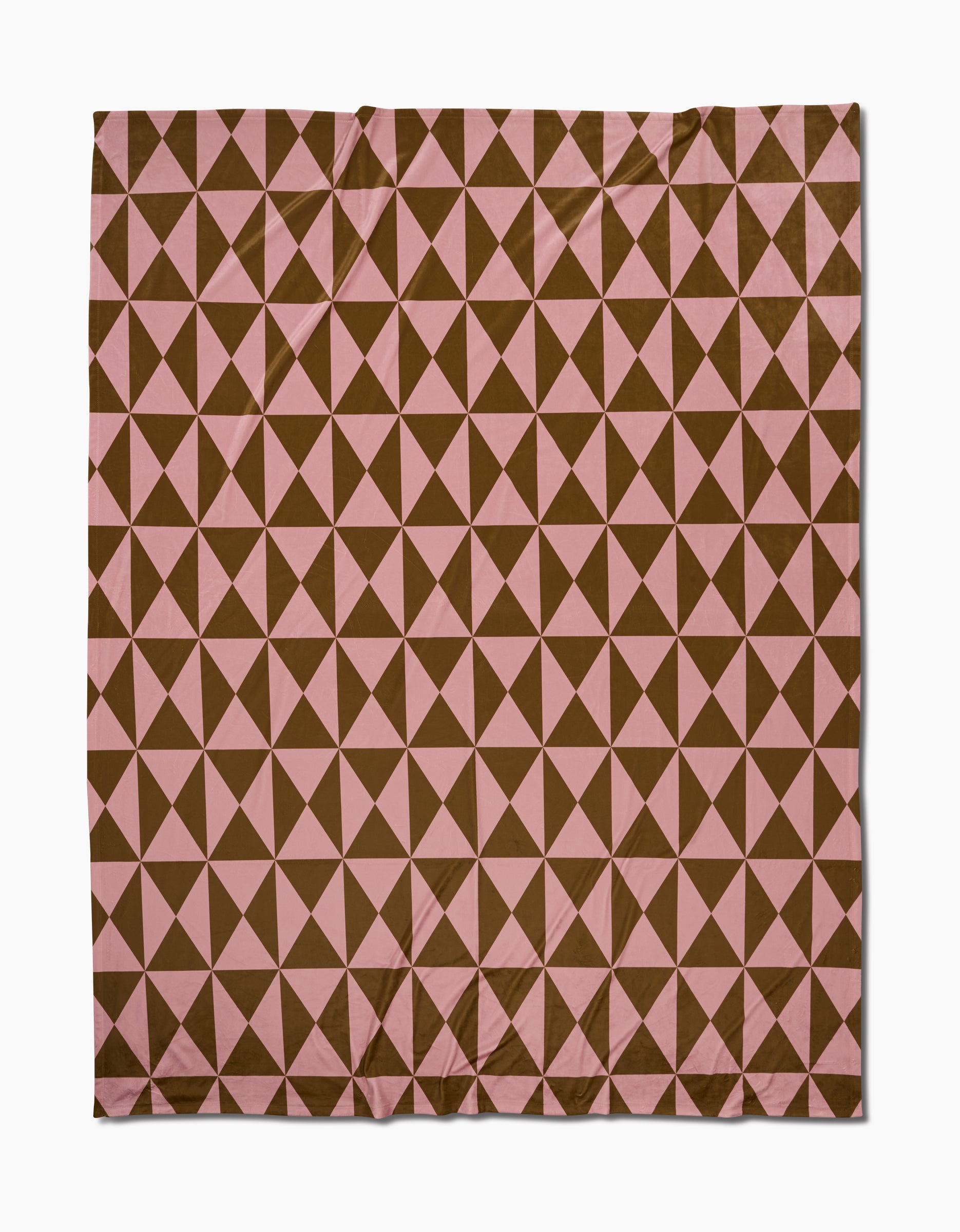 The Geometry Bronze Butter Blanket features a grid of alternating brown and pink triangles forming a diamond pattern, all crafted from eco-friendly, recycled materials.