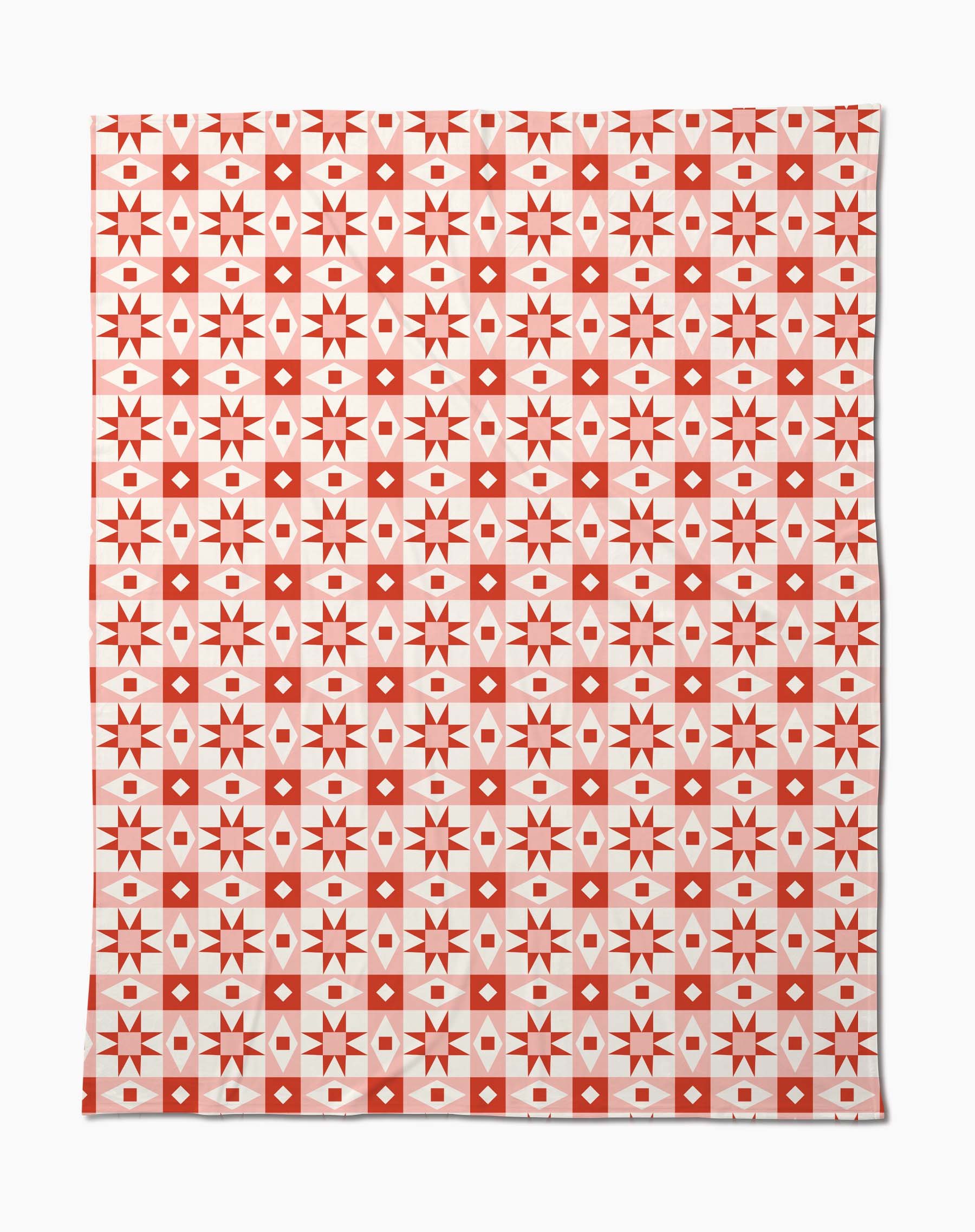 The Chalet quilt by Charlie Rowan Designs is a rectangular piece made from recycled materials, featuring red and white geometric patterns with alternating star, diamond, and cross squares in a symmetrical grid.