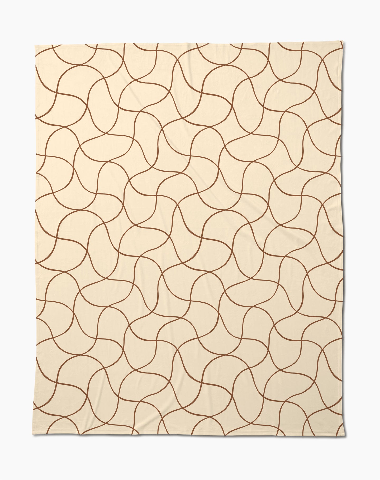 The Clarity throw by Geometry features a beige butter hue with abstract, wavy brown lines—a soft, cozy blanket perfect for relaxing evenings.