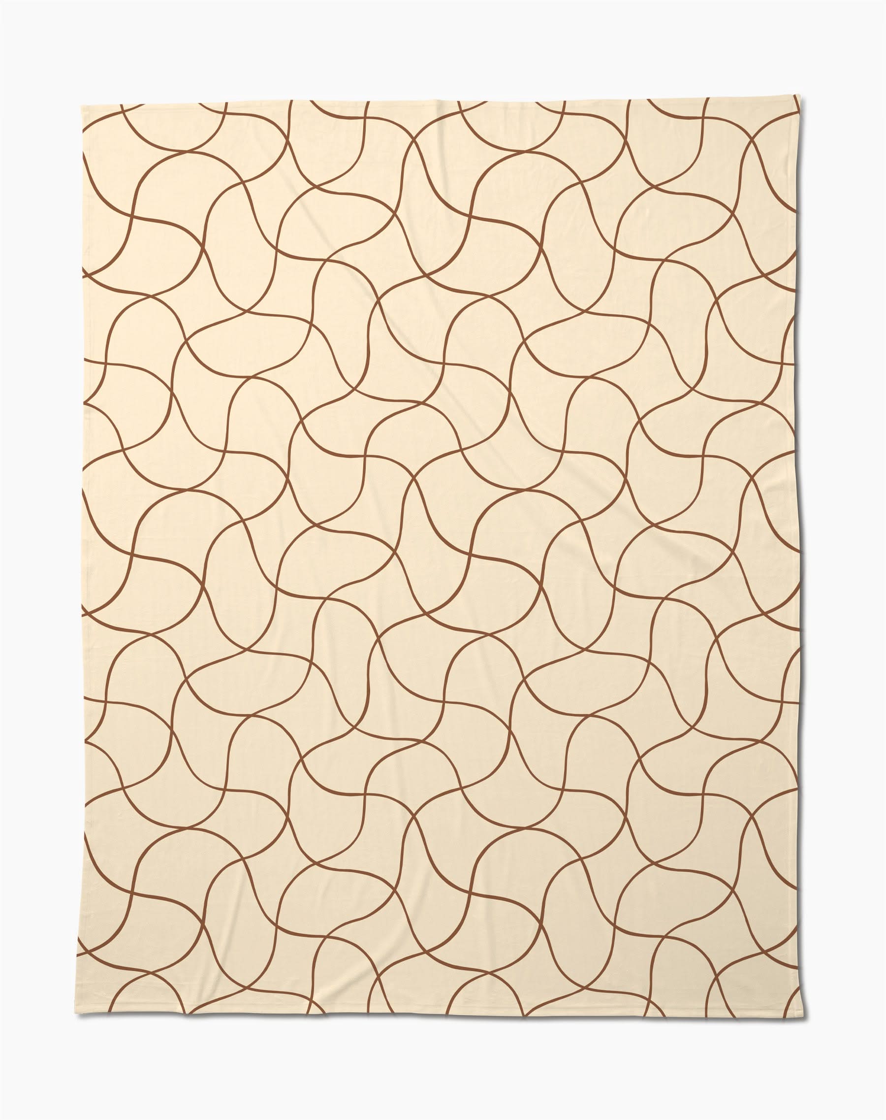 The Clarity throw by Geometry features a beige butter hue with abstract, wavy brown lines—a soft, cozy blanket perfect for relaxing evenings.