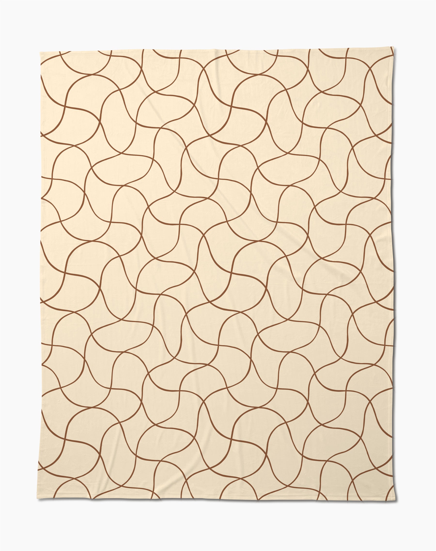 The Clarity throw by Geometry features a beige butter hue with abstract, wavy brown lines—a soft, cozy blanket perfect for relaxing evenings.