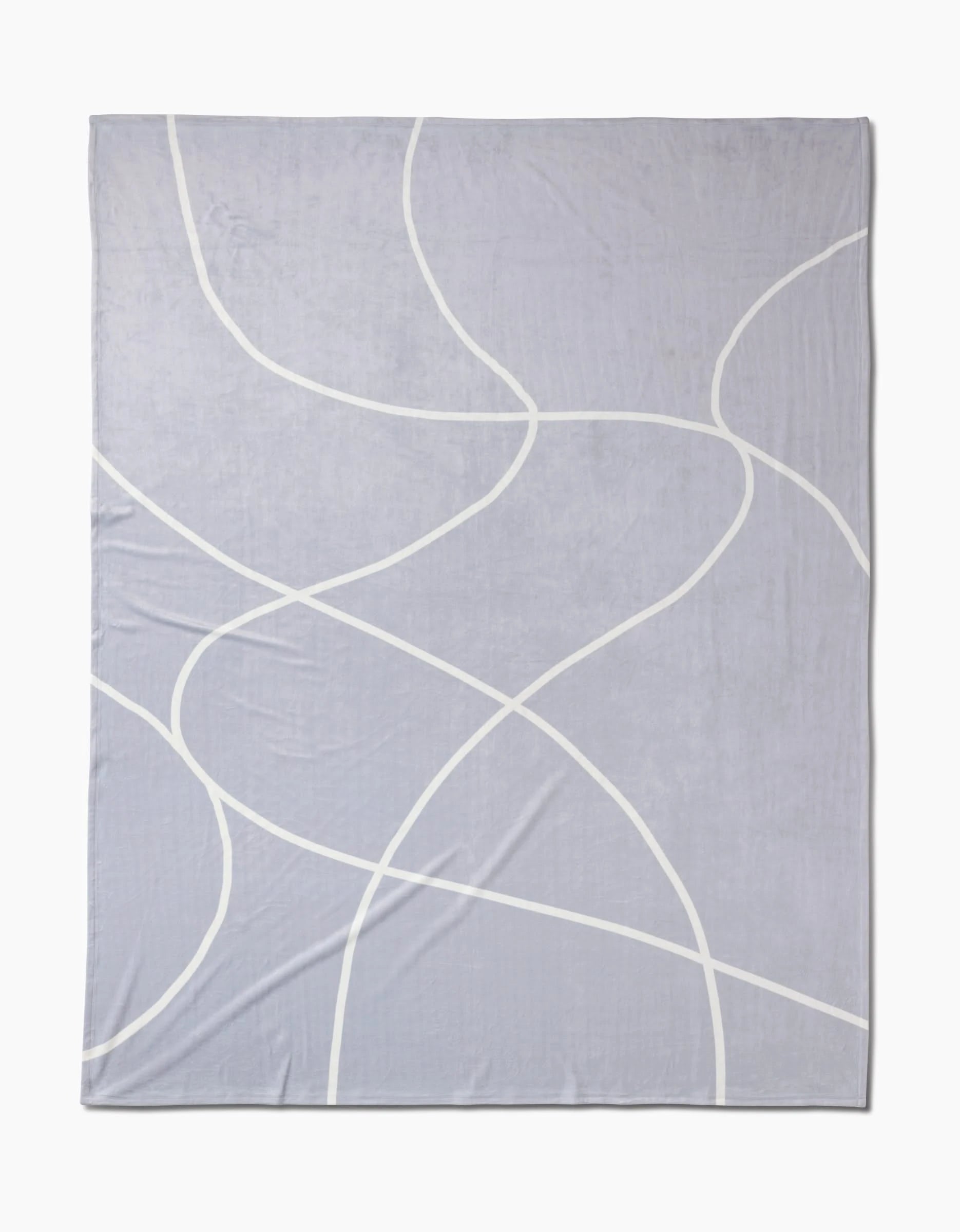 The Crossover Eco-Friendly Blanket by Geometry features a light gray base with intersecting, thin wavy white lines in a simple, modern design.