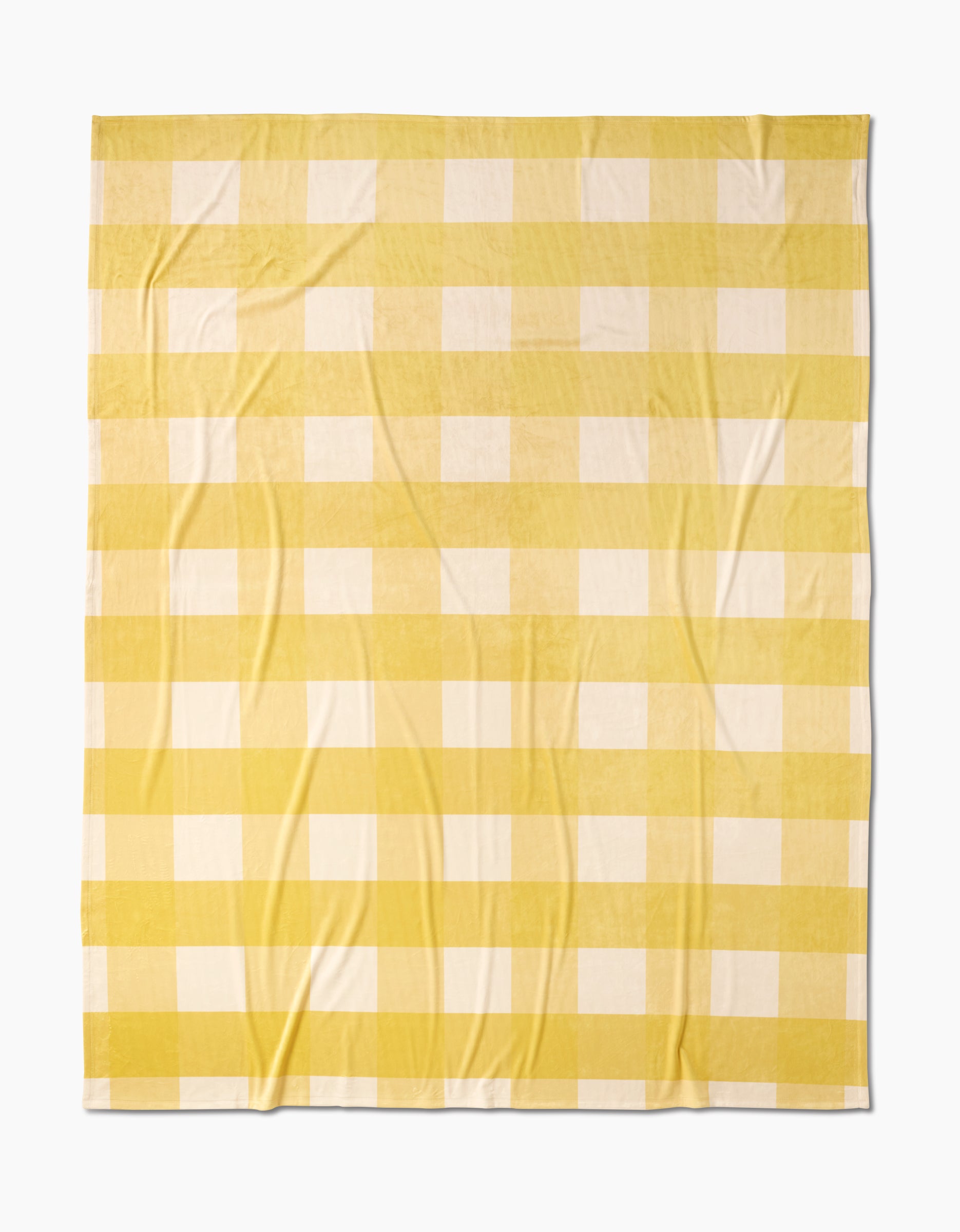 Geometry’s Lemonade Gingham Butter Blanket features a yellow and white checkered pattern with evenly spaced stripes, made from soft, eco-friendly recycled materials.