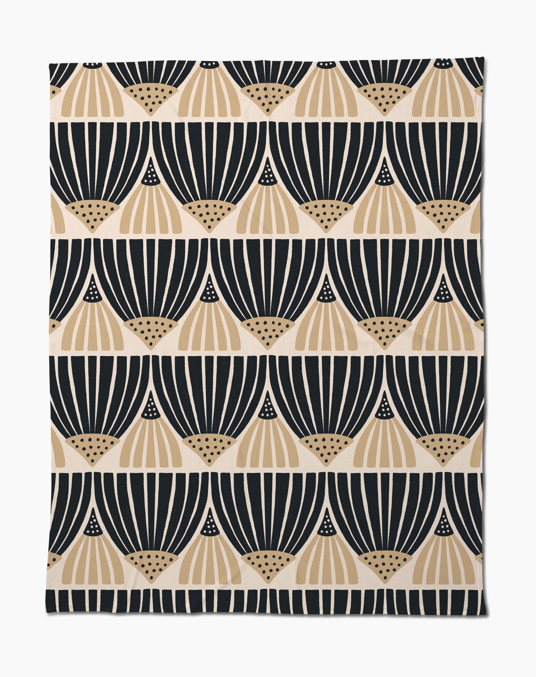 The Letitia Dark Butter Blanket by Amy MacCready features black and tan geometric fan patterns on white, arranged in horizontal rows. Made from eco-friendly recycled materials, it offers a modern, minimalist style.