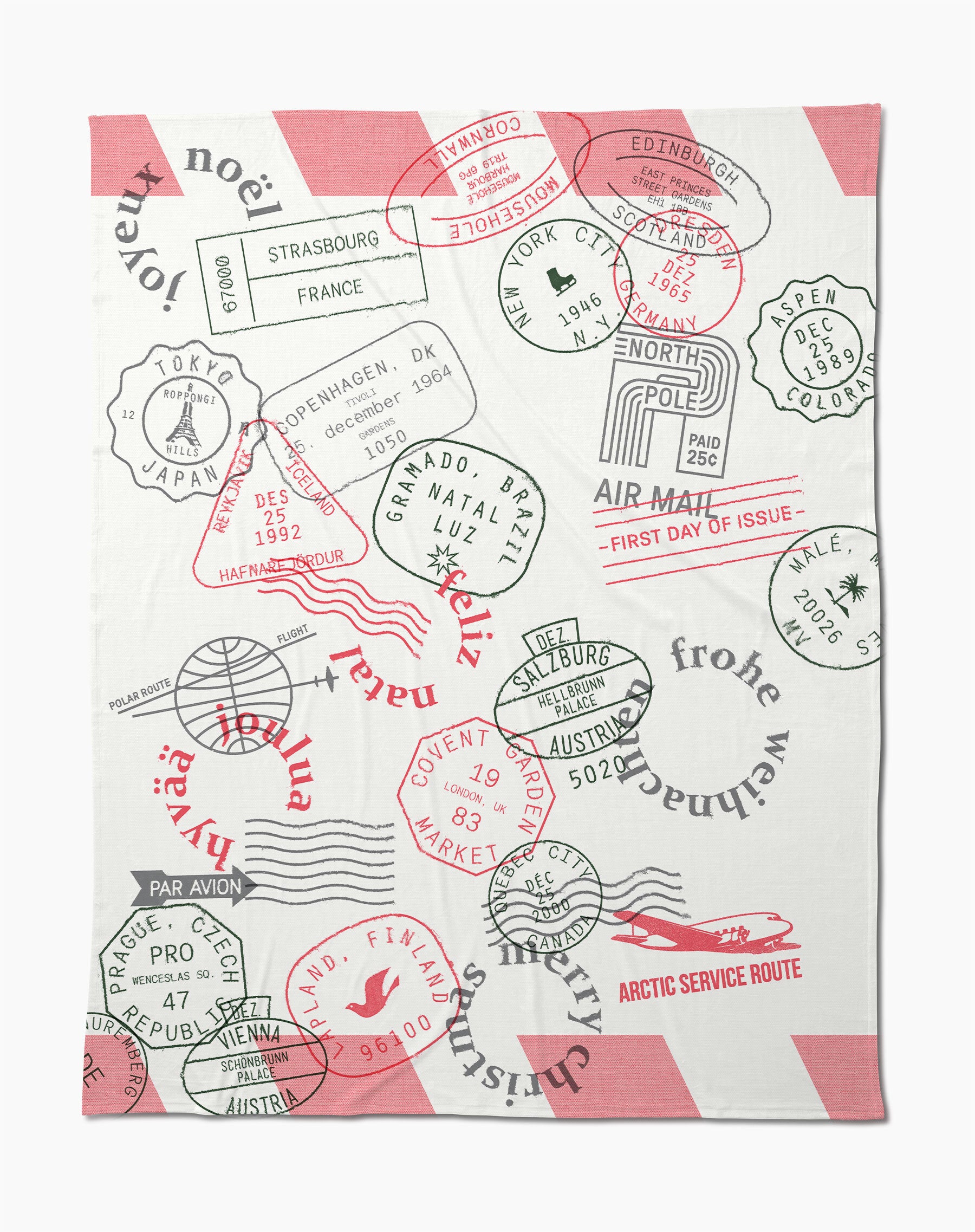 The Geometry Nordic Mail Butter Blanket is a soft white throw with pink diagonal stripes, colorful passport stamps from cities like Tokyo, Paris, New York, frohe Weihnachten text, and travel-themed graphics—perfect for cozy adventures.