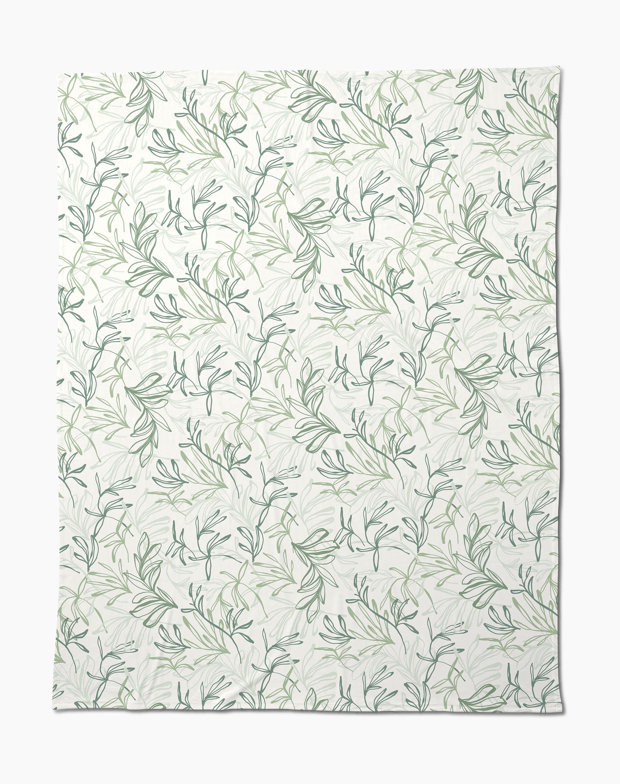 The Organic Foliage Butter Blanket by Kris Ruff is white, silky soft, and features a subtle repeating pattern of green leafy branches and vines for a delicate botanical look.
