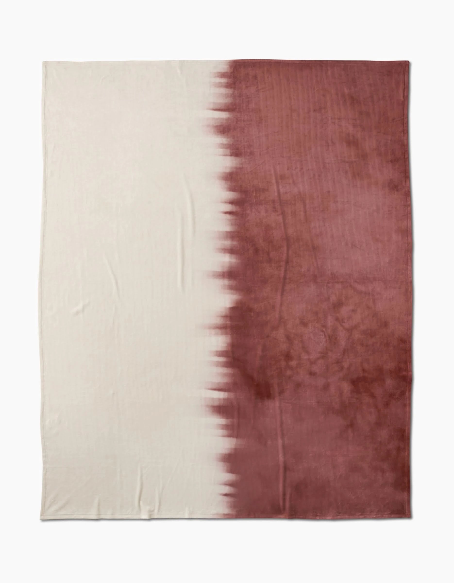 The Sundae by Geometry is a rectangular, eco-friendly blanket made from recycled materials. It features a two-tone design: off-white on the left and deep reddish-brown on the right, with a jagged blended transition between the colors.