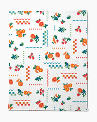 The Sweet Pickings Butter Blanket by Aubrey Fairchild features a vibrant pattern of oranges, strawberries, leaves, and geometric shapes on white, crafted from recycled materials for silky softness.