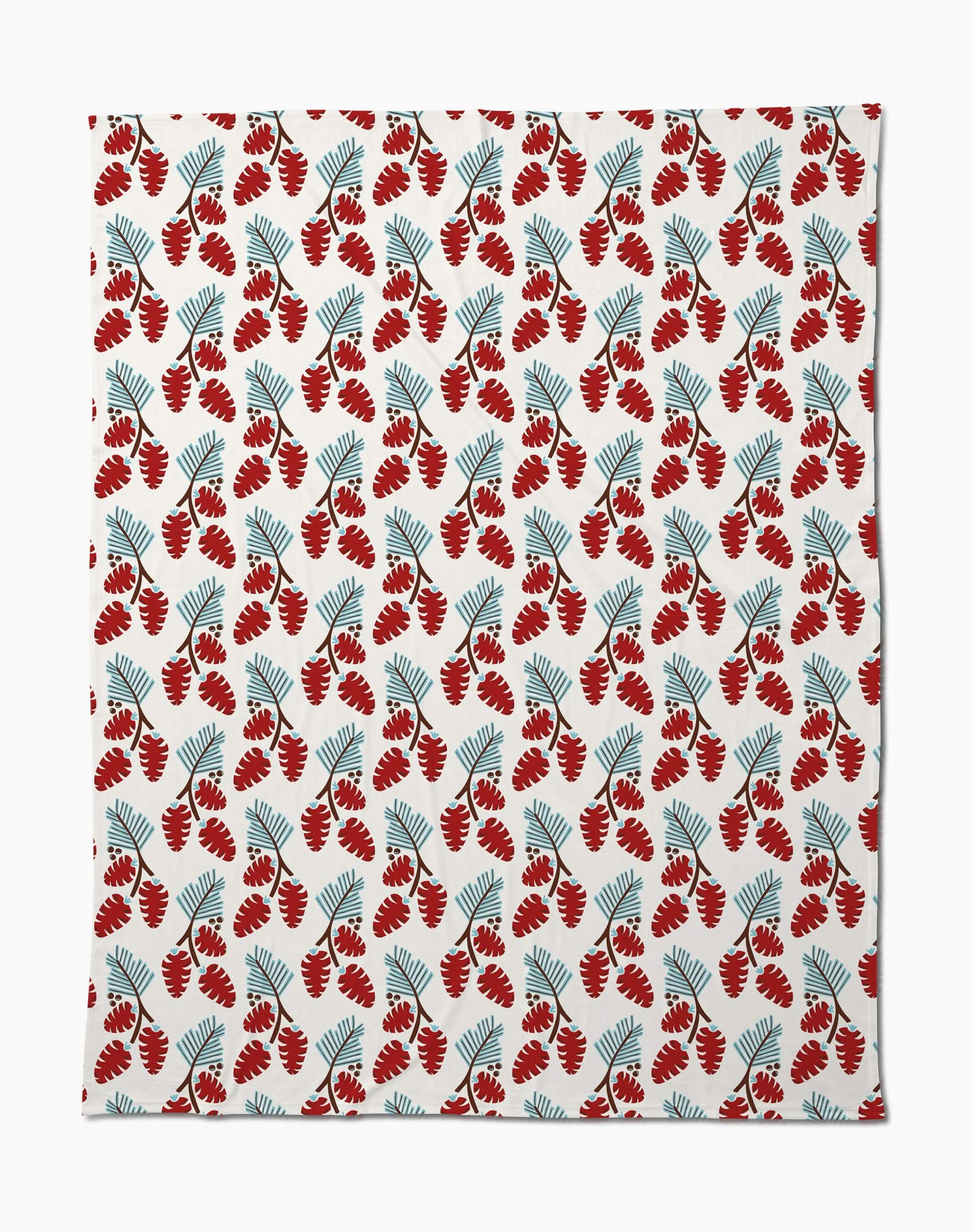 The Winter Forage throw blanket by Geometry features a soft, silky texture and a repeating pattern of red pinecones and blue-green pine needles on a white background.