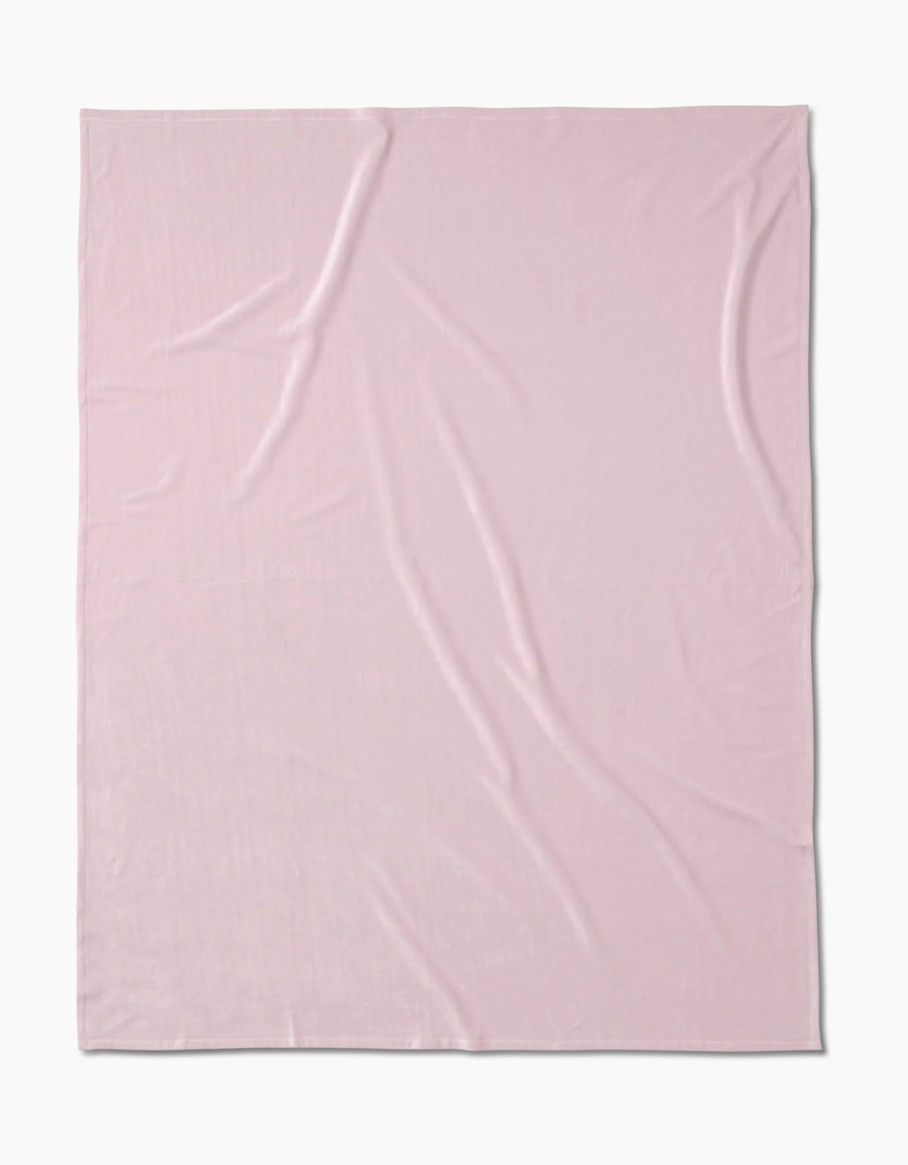 A light pink, square-shaped Berry Shortcake blanket by GEOMETRY is spread flat on a white background, highlighting its silky softness with a few visible creases and folds.