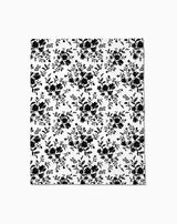 The Danelys Sidron Botanical Silhouettes Charcoal blanket or sheet is white with a repeating black floral and leaf pattern, offering silky softness for a timeless, elegant style.