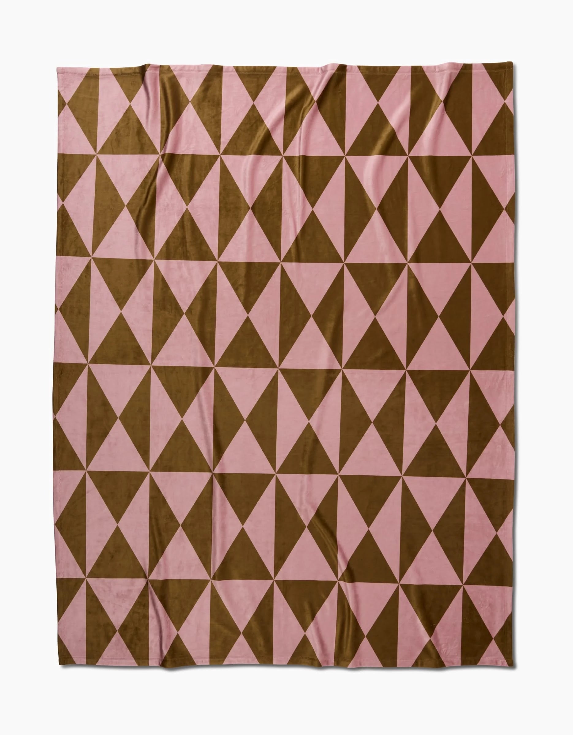 The Geometry Bronze Butter Blanket showcases a geometric pattern with alternating brown and pink triangles in a grid, creating a repeating diamond design on eco-friendly fabric.