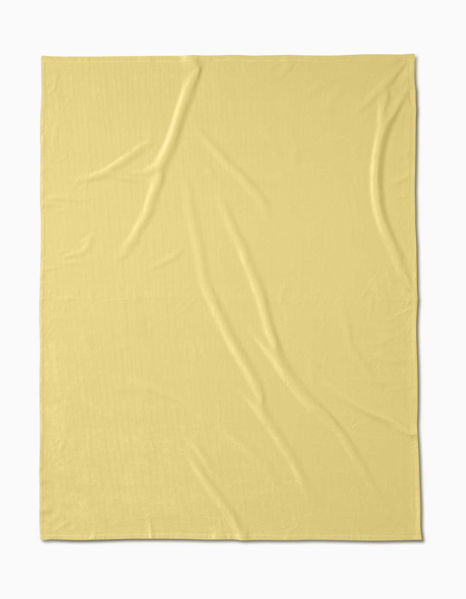 The Geometry Butter Yellow Butter Blanket, made from recycled materials, is spread flat on a white background, with light yellow color and visible slight wrinkles and creases.