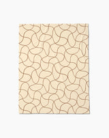 The Geometry Clarity throw blanket is beige and rectangular, featuring a soft texture with an abstract pattern of curving brown lines that form a repeating, interconnected design across the surface.