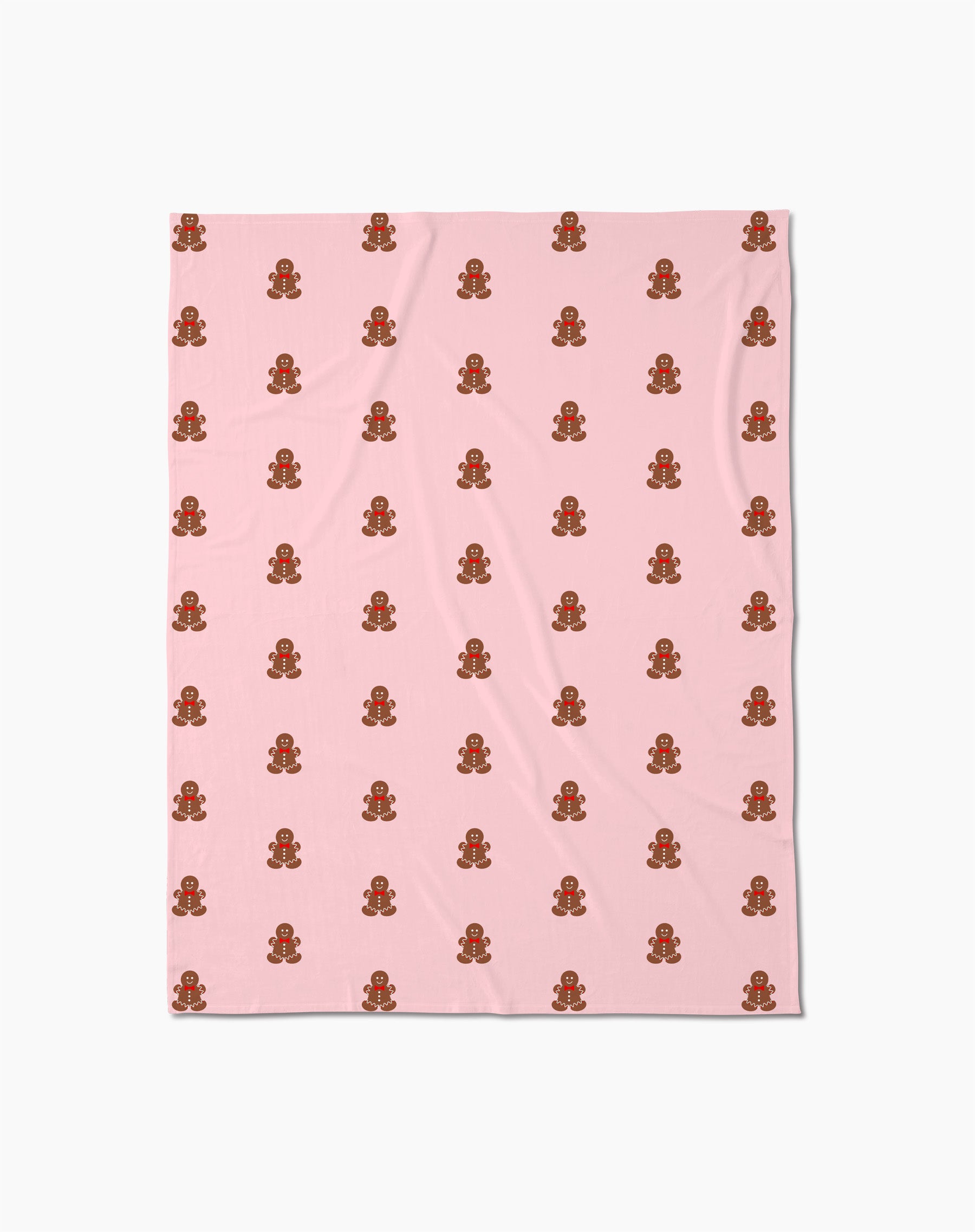 The Cozy Gingerbread Butter Blanket by Geometry features a light pink design with evenly spaced small gingerbread men adorned with icing and buttons, arranged in rows and columns for a charmingly soft throw.