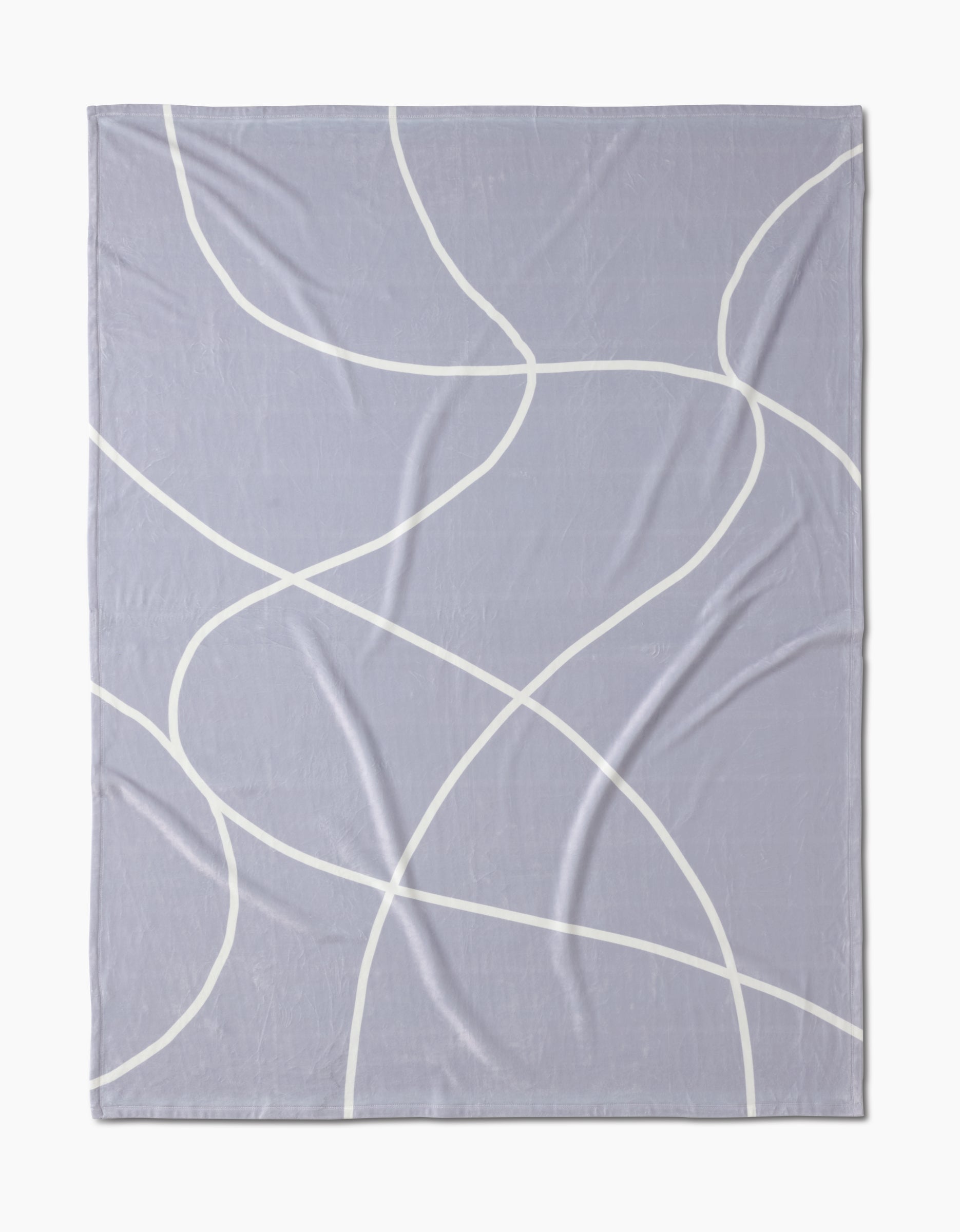The Geometry Crossover is a light purple, eco-friendly blanket with a minimalist pattern of thin, curving white lines that intersect and loop across the surface.