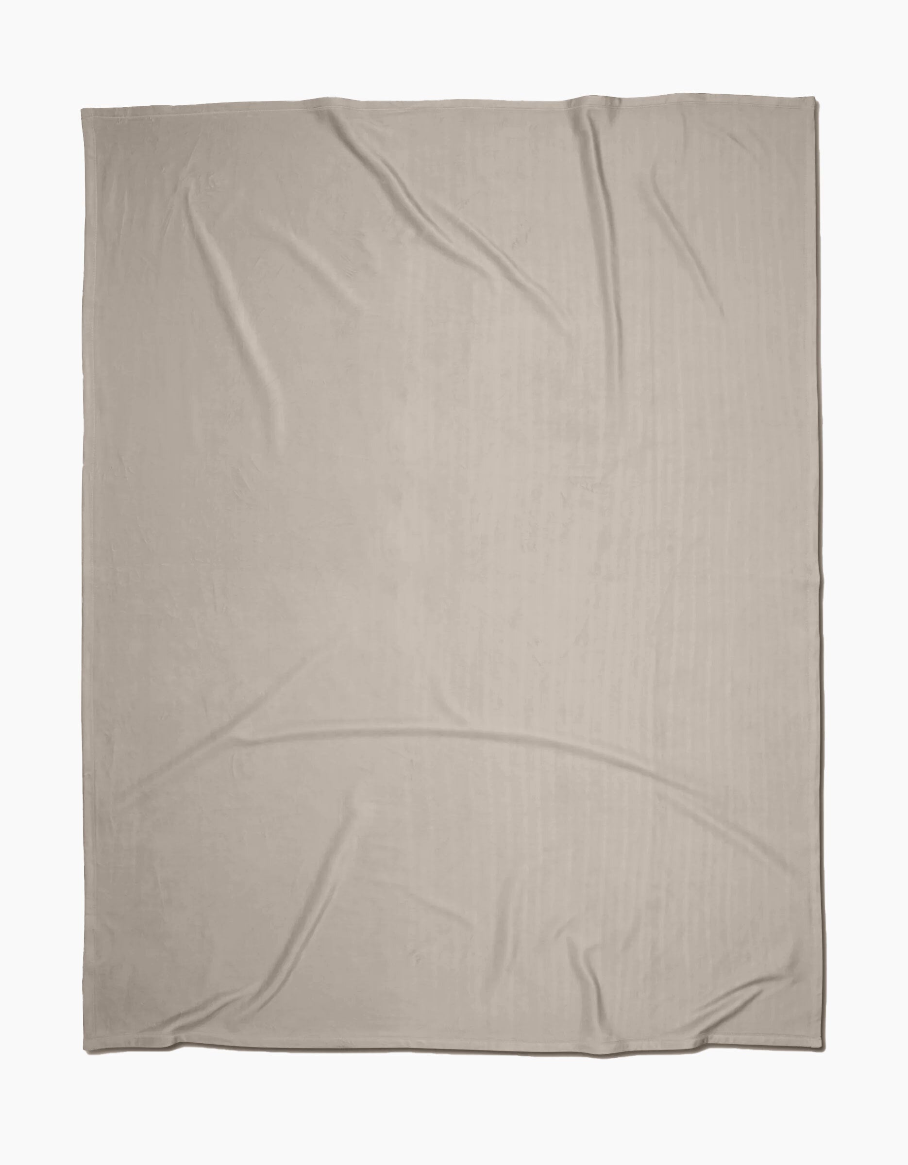 The GEOMETRY Desert Haze Butter Blanket, crafted from recycled materials in light beige with slight wrinkles, is laid flat on a white background.