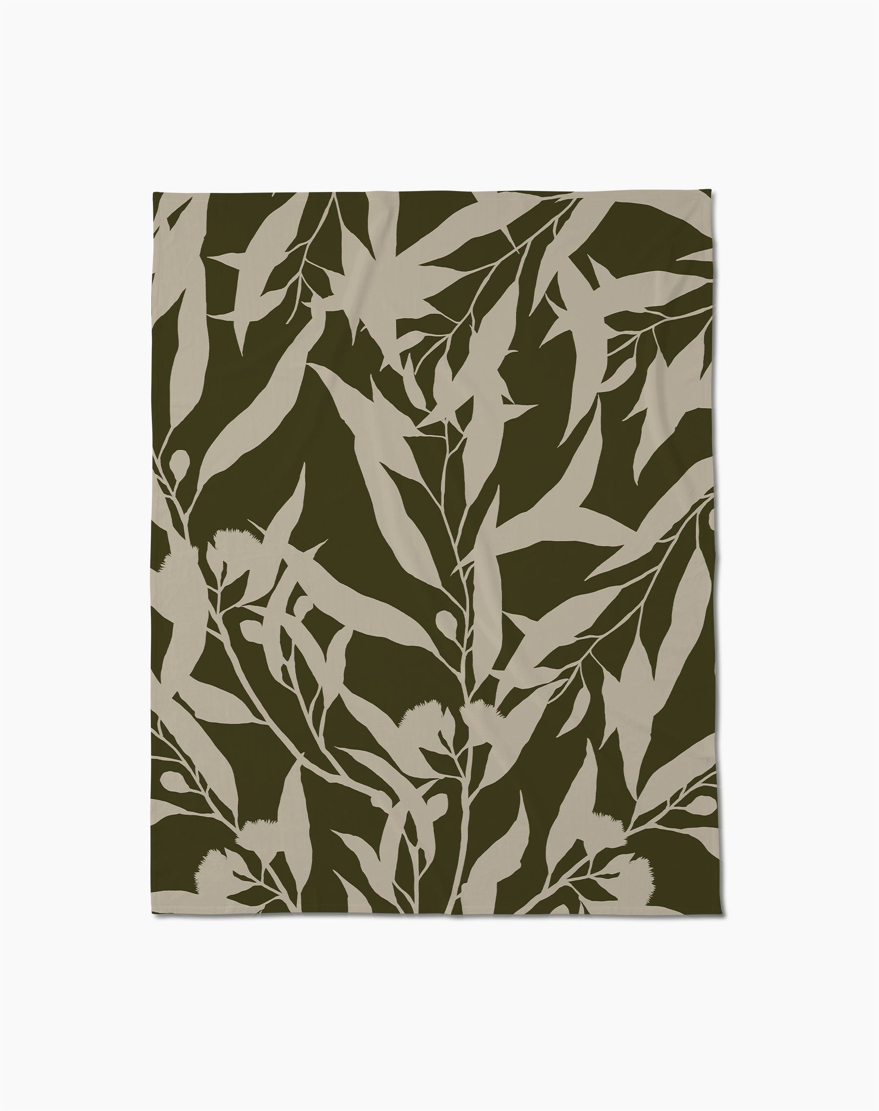 The Geometry Fable Butter Blanket features a botanical pattern of beige leafy branches on an olive green background—perfect for cozy evenings.