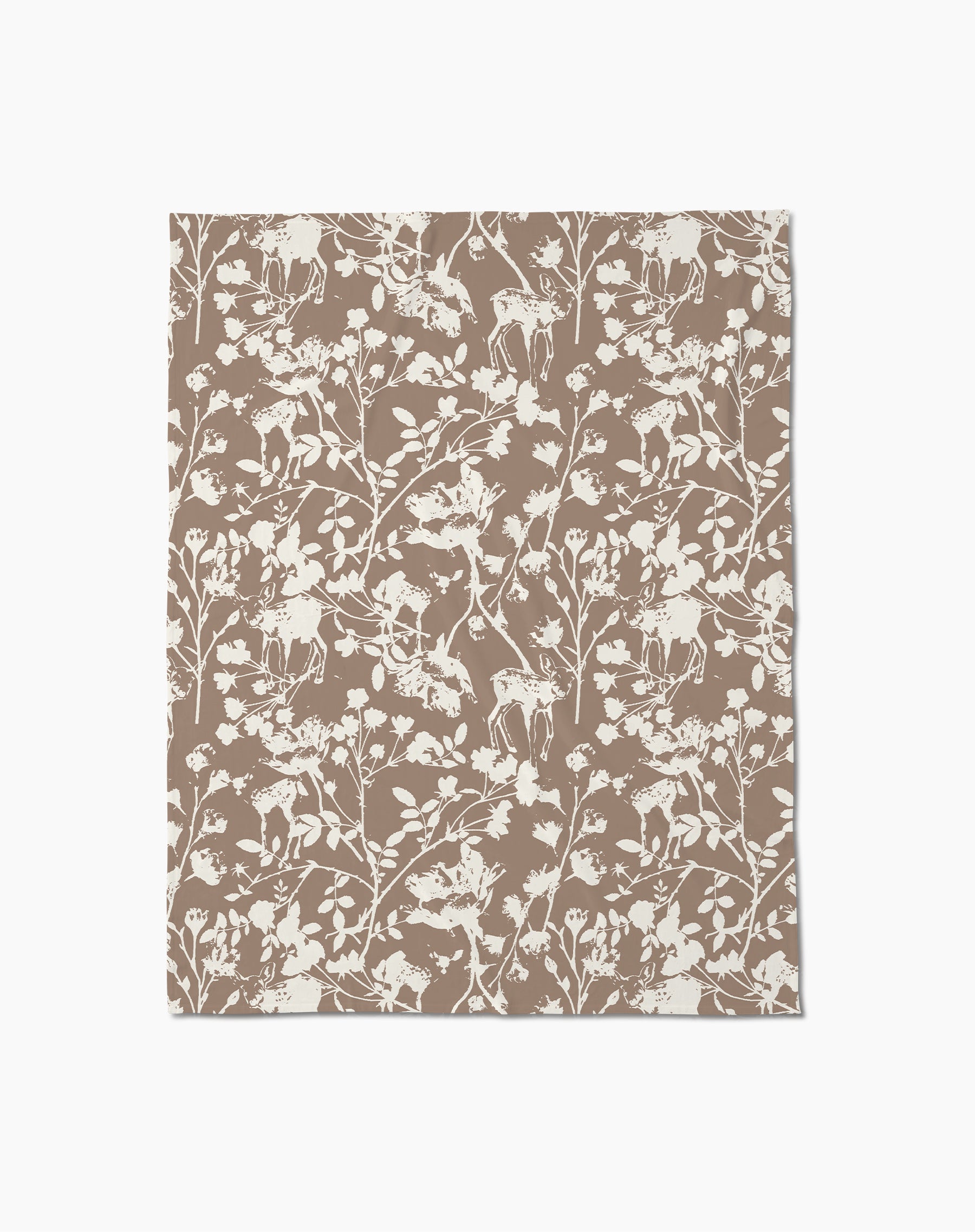 The Forestry throw blanket by Geometry is a soft brown blanket featuring an intricate white forest-themed pattern with deer, birds, flowers, and branches on a plain background.