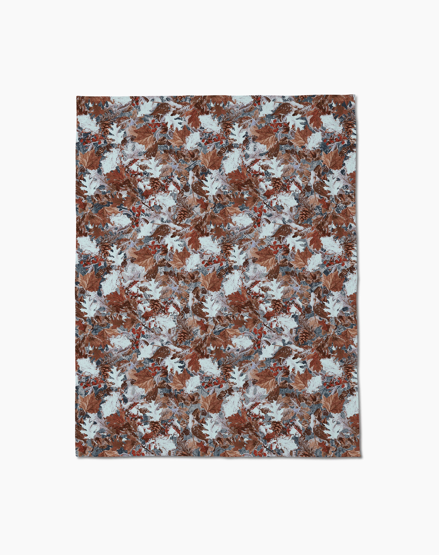 The Geometry Frosty Camo rug displays a dense, repeating pattern of brown, blue, and white leaves on a textured base for an autumn-inspired look. Shown on a plain white surface, its design evokes the feel of recycled blankets.