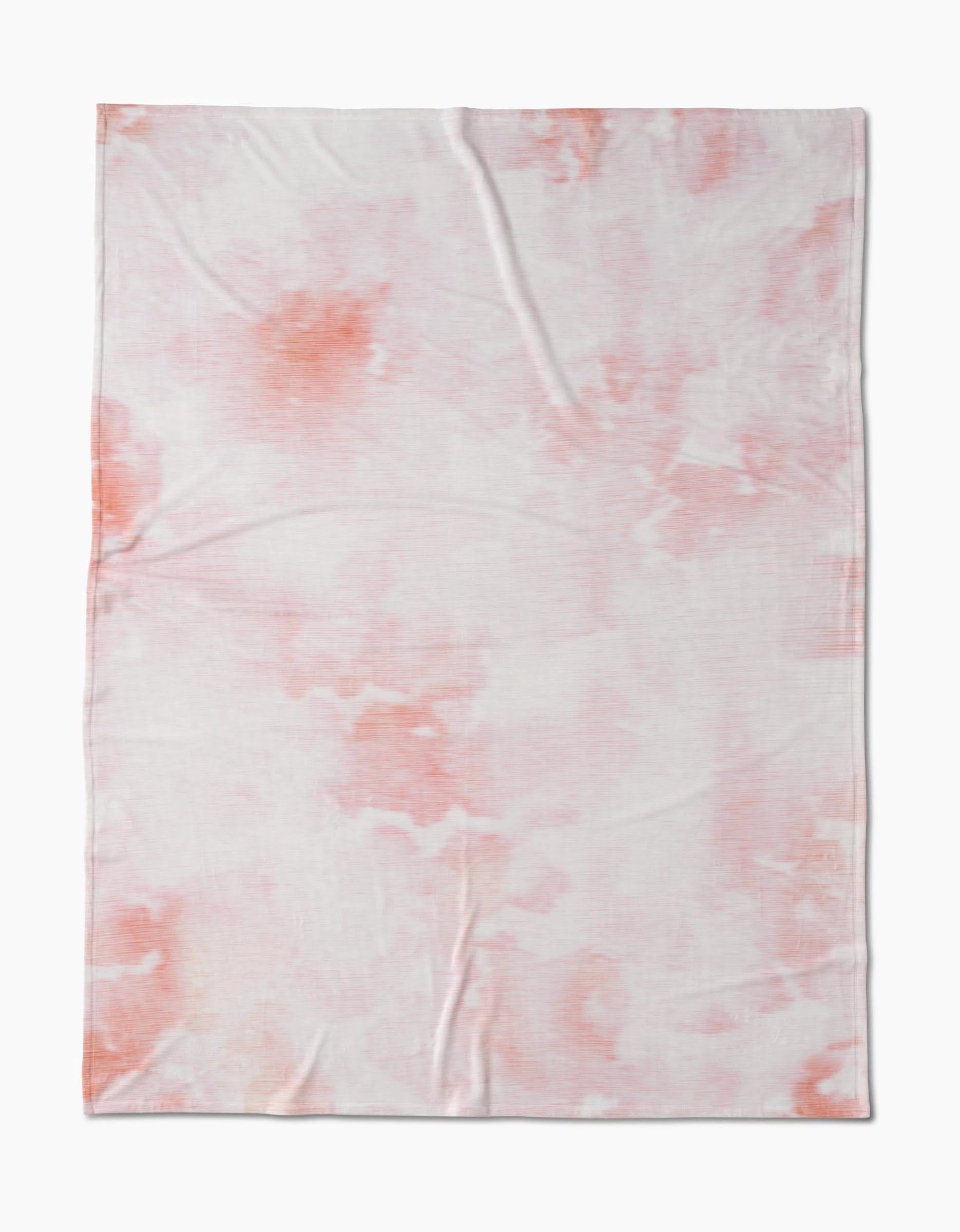 Geometry’s In the Clouds features a soft, lightweight fabric with silky texture and a subtle pink and orange tie-dye pattern, shown laid flat with slight wrinkles.