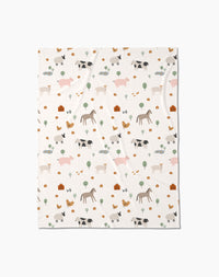 The Light Farm Animals Butter Blanket by Coit Creative is made from eco-friendly recycled materials and features soft pastel cows, pigs, horses, chickens, trees, and barns in a charming repeating pattern.