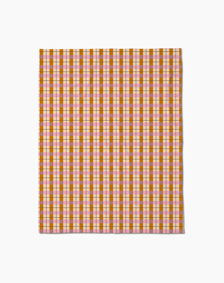 The Megan Roy Maple Plaid throw blanket features a soft feel and a plaid pattern with pink, orange, red, and yellow stripes on a white background.