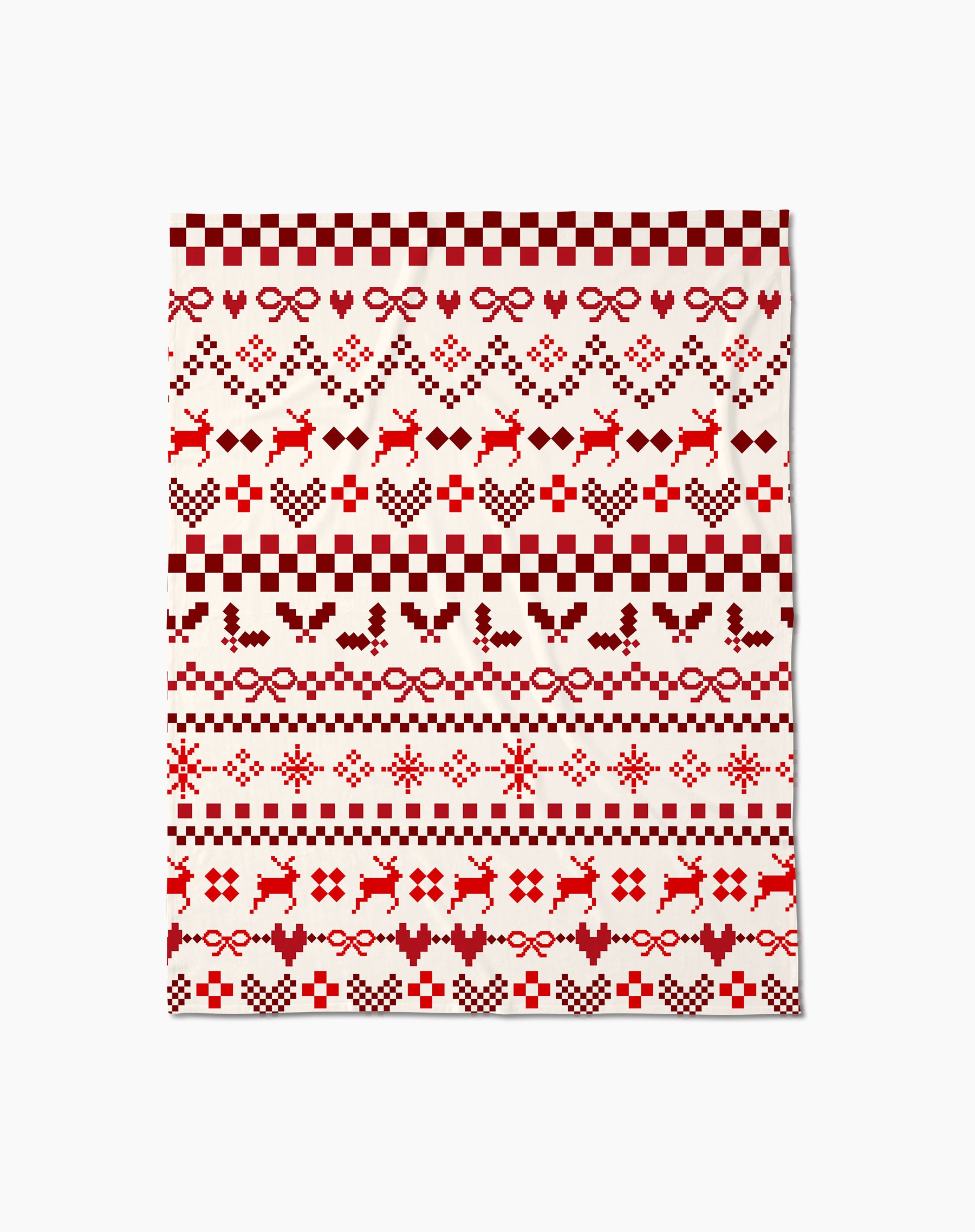The Merry Pixels Butter Blanket by Geometry is a rectangular throw with a red and white Nordic Christmas pattern featuring reindeer, hearts, holly, bows, snowflakes, and geometric designs on a soft white background.
